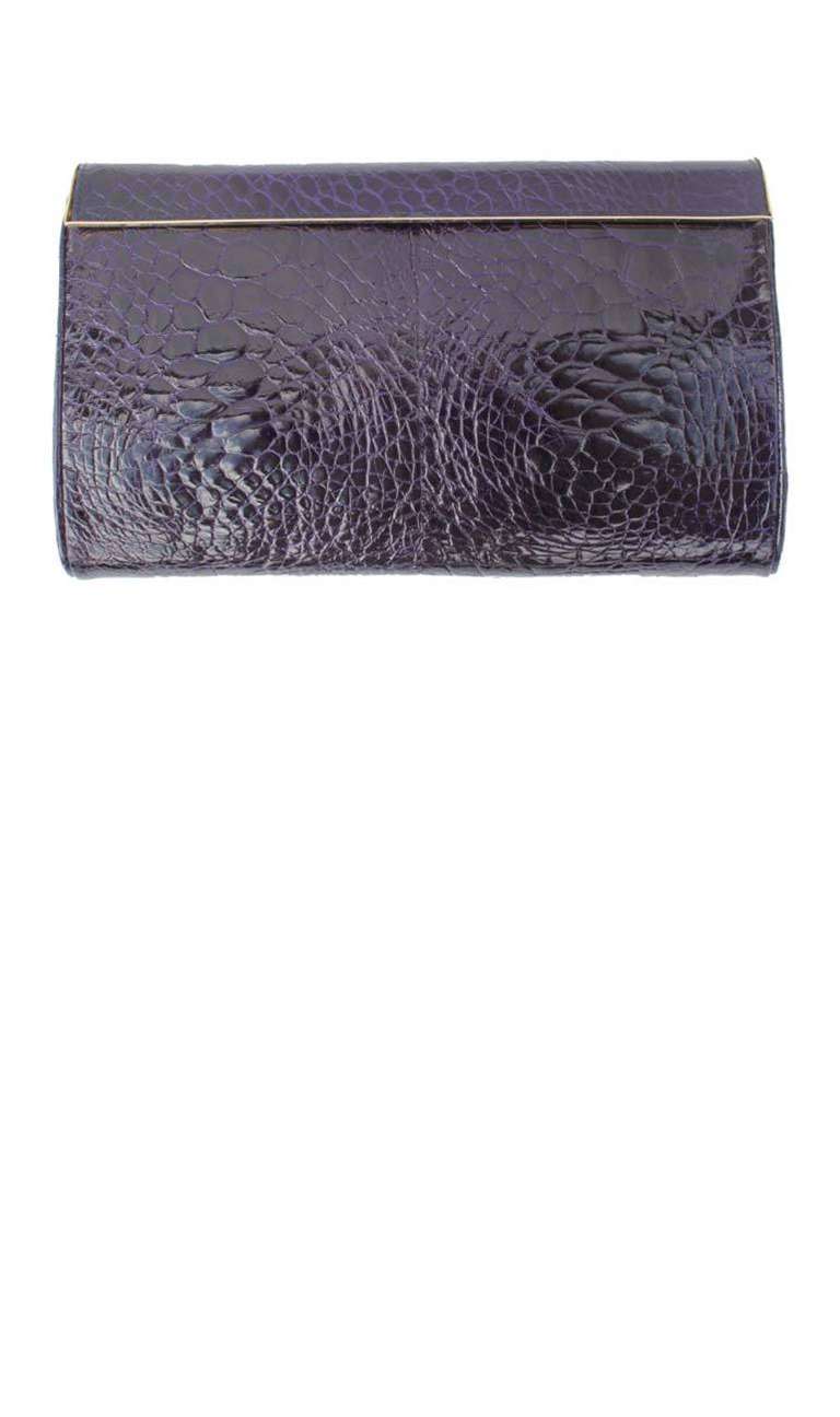 Guido Borelli crocodile porosus clutch bag from the 1960's. The bag is in a dark royal purple and is lined in moire, with gilt metal detailing and edging.

Manufacturer: Guido Borelli

Size as marked: 9.25 in