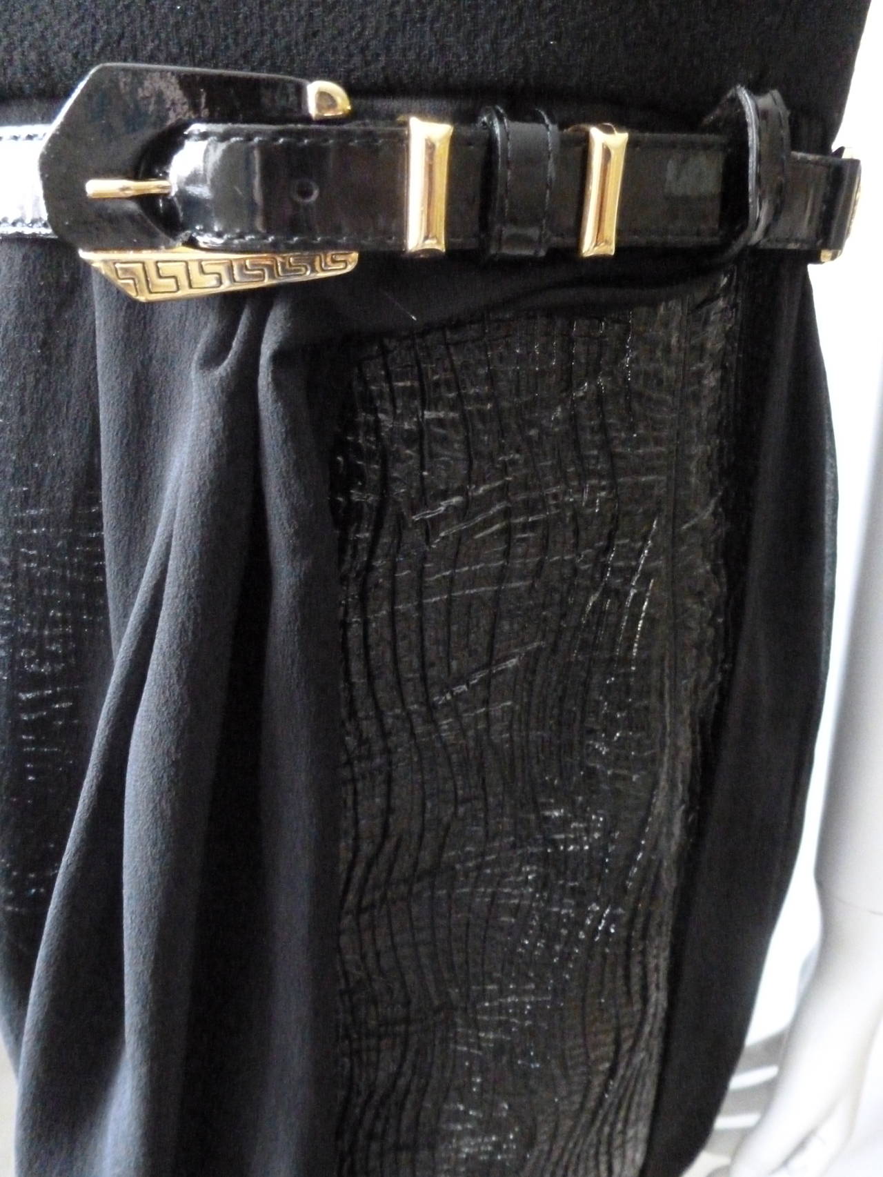 Iconic and rare Gianni Versace Couture black crocodile effect patent leather, with silk chiffon overlay Empire silhouette sleeveless dress from the Fall 1994 collection. The dress features a wool crepe bodice and a patent leather and gold-tone metal
