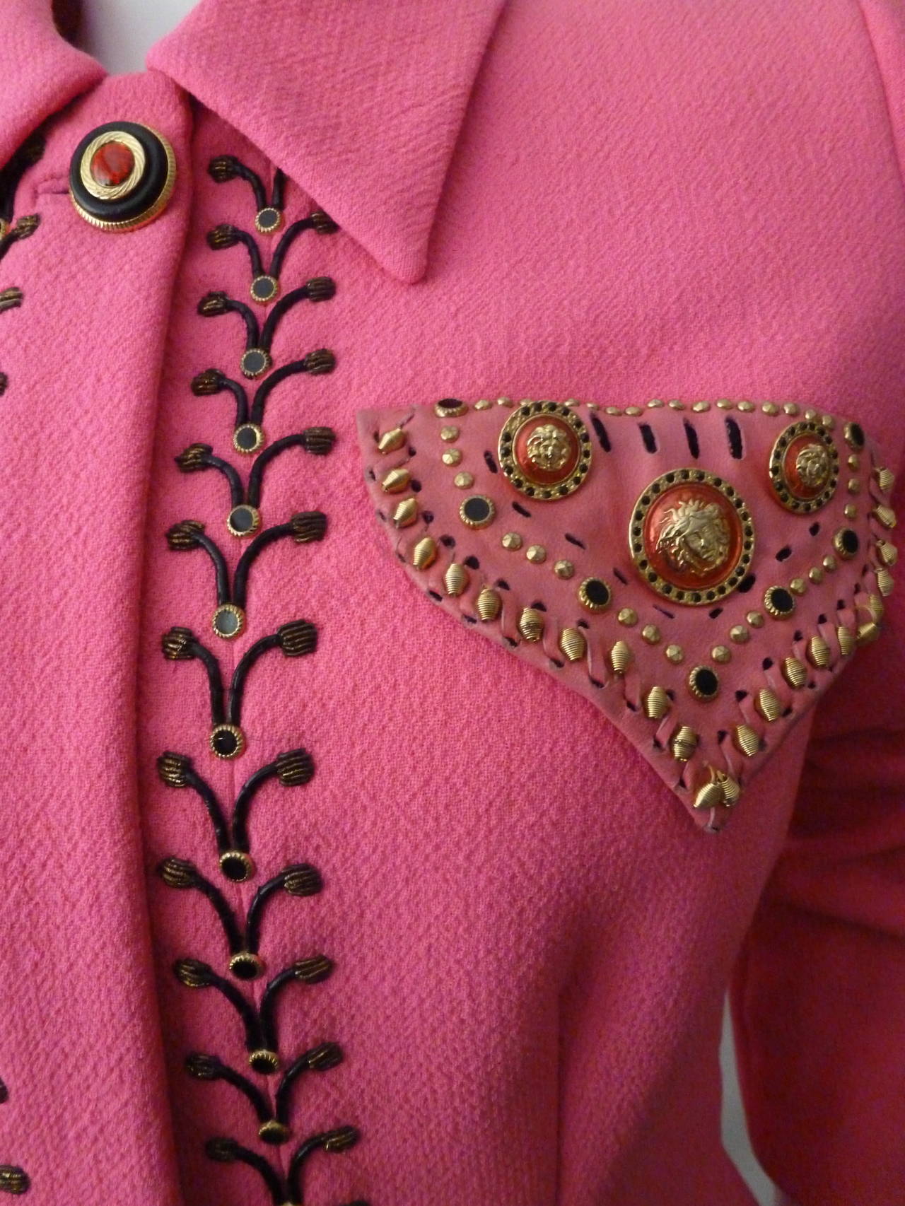 Iconic and rare Atelier Versace shocking pink wool crepe cowboy western inspired jacket from the Fall 1992 Atelier Bondage collection, shown at The Ritz in Paris.

The jacket features black thong embroidery, edged with gilt purl wire tassels,