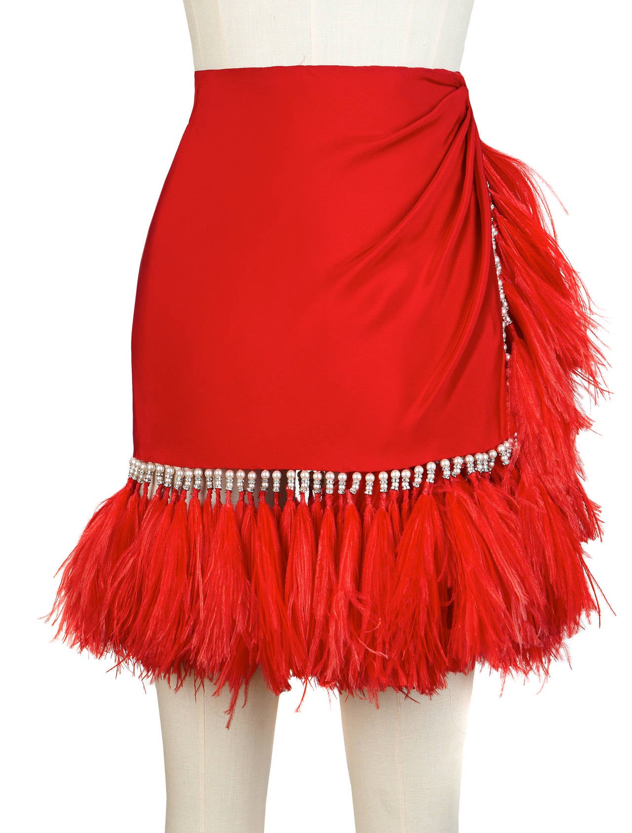 An important Atelier Versace red silk Maribou feather wrap skirt with faux pearl and strass embroidery from the Fall 1990 Atelier Versace, shown at The Ritz in Paris.

Marked an Italian 38.

Manufacturer - Alias S.p.a.