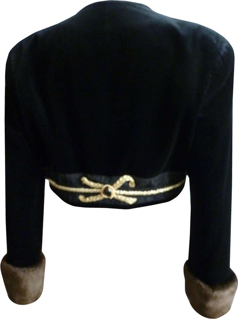 Rare Byblos velvet evening bolero jacket with gilt rope and jewel application from the Autumn/Winter 1991 collection. The bolero also features fur detailing to the cuffs.

Marked an Italian 40.

Manufacturer - Byblos S.p.a.