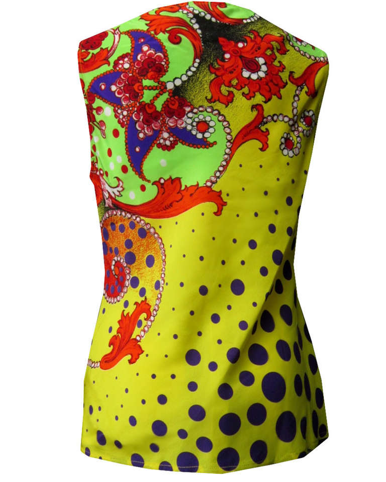 Gianni Versace Pret-a-Porter print silk top from the Spring 1991 Pop-Art collection. The sleeveless top with draped neckline features a vibrant purple polka dot and multi-coloured jewel Baroque print.

Marked an Italian 38.

Manufacturer - Alias