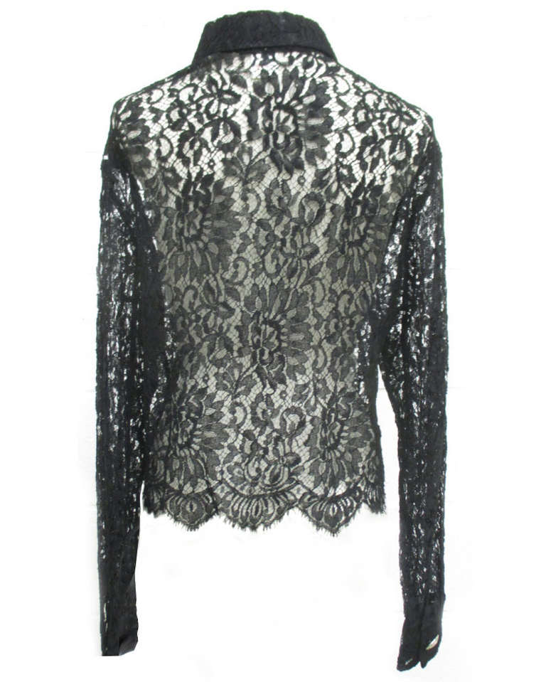 Gianni Versace Couture black lace blouse from the Spring/Summer 1994 Punk collection. The silk lace blouse is secured at the neck by a single silver metal and painted Medusa embossed button. The blouse featured in the advertising campaign for the