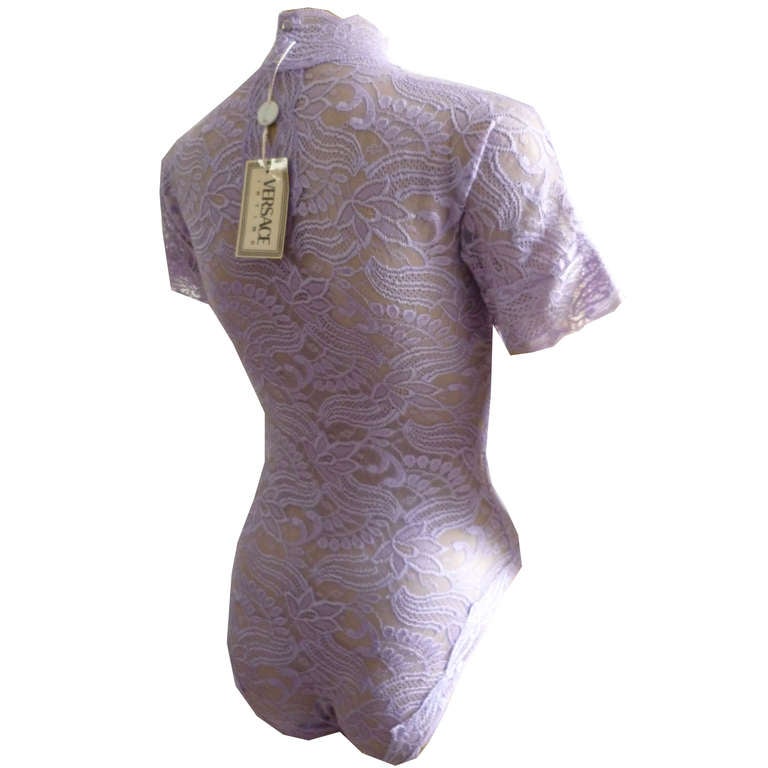 Gianni Versace Intimo short sleeved lilac lace stretch bodysuit from the Autumn/Winter 1991 collection. The bodysuit is new with tag.

Marked an Italian 42.

Manufacturer - Alias S.p.a.

Fabric content - 50% cotton  20% polyester 25% nylon 5%