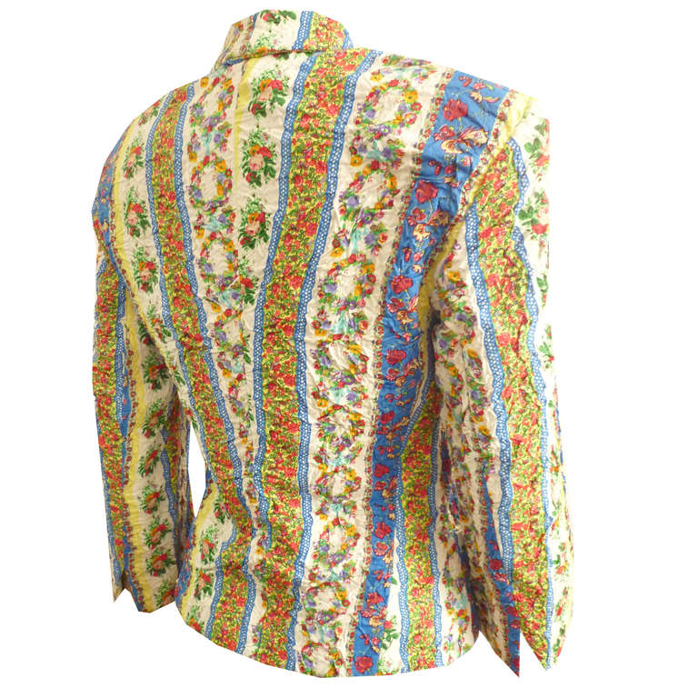 Gianni Versace floral print punk jacket from the Spring/Summer 1994 Versus collection. The jacket is permanently creased to enhance the punk inspired look. The double-breasted jacket is secured to the front by a series of metal painted