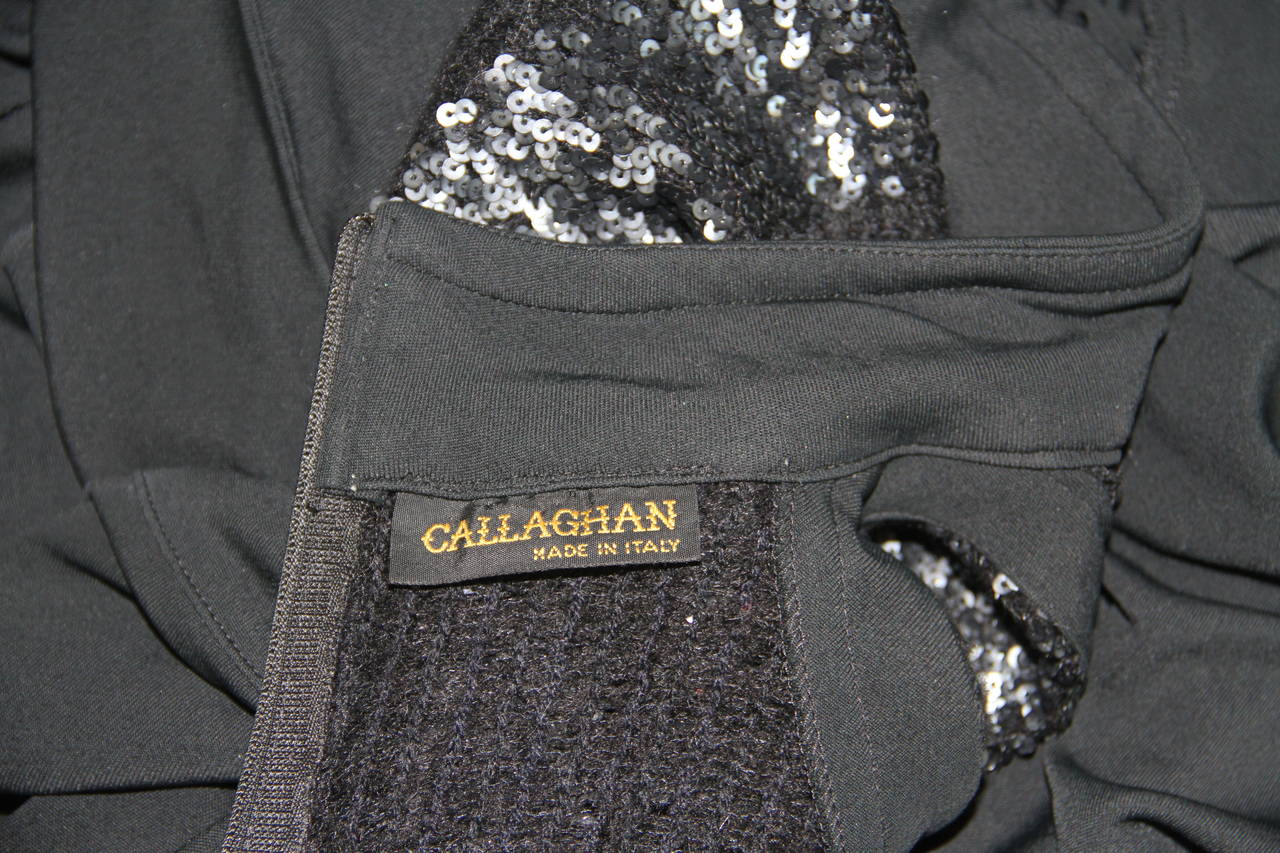 A very rare Gianni Versace For Callaghan black jersey with sequin application jumpsuit from the 1970's. The jumpsuit features concealed pockets to the front.

Marked an Italian size 40.

Fabric content - 90% viscose / 5% acrylic / 5% acetate