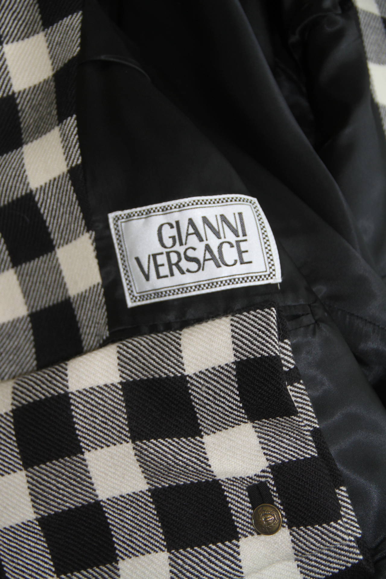 A rare Gianni Versace black and white checked jacket with suede collar from the Fall 1992 Men's Bondage collection.

Marked an Italian size 48.

Manufacturer - Alias S.p.a.

Fabric content - 100% wool with suede application