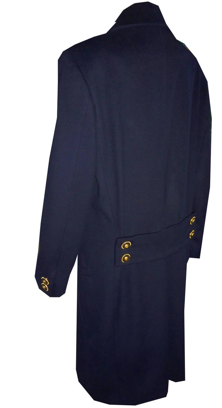 Stunning Gianni Versace Couture dark navy blue double breasted overcoat from the Autumn / Winter 1993 collection. The coat features a series gilt and leather buttons with gilt Medusa insert detail. The coat also features half-belt detailing to the