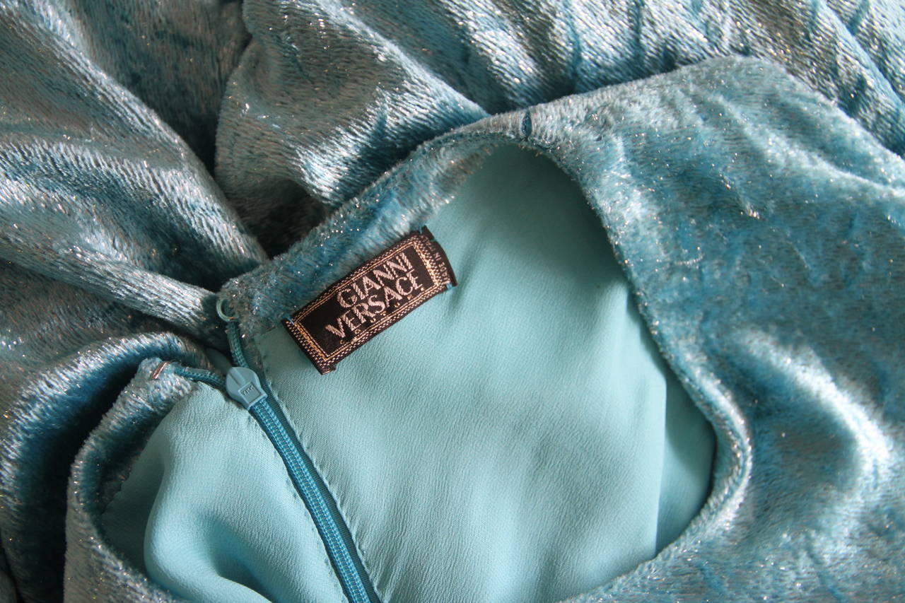 Very rare Gianni Versace turquoise metallic thread silk velvet plisse babydoll cocktail dress from the Spring 1994 Punk collection.

The fabric of the dress is permanently creased, to further enhance the punk inspired look of the piece.

The