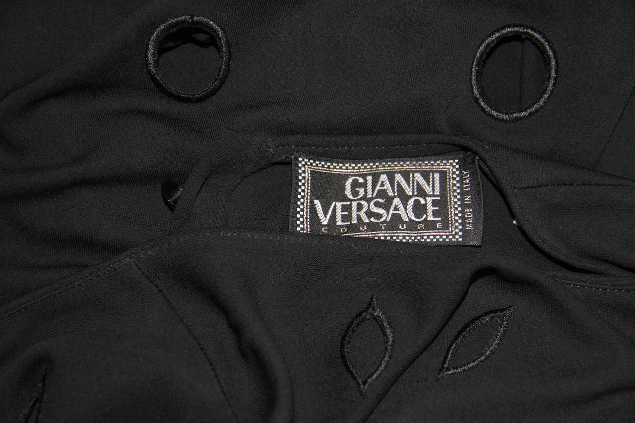 Gianni Versace cut-out jersey sleeveless dress from the Spring 1994 Punk collection. The dress features cut-out detailing to the neckline and hem.

Marked an Italian size 42.

Manufacturer - Alias S.p.a.

Fabric content - 100% rayon