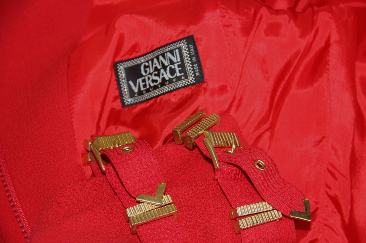 Gianni Versace red wool bondage buckle suit from the Fall 1992 Bondage collection.

The jacket features silk and metal bondage buckle detailing to the neckline, waist and cuffs.

Marked an Italian size 38.

Manufacturer - Alias