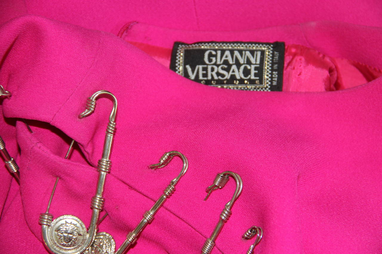 Museum quality Gianni Versace shocking pink safety pin dress from the Spring 1994 Punk collection. The dress was featured in the advertising campaign for the collection and on the front cover of W Magazine.

Marked an Italian size