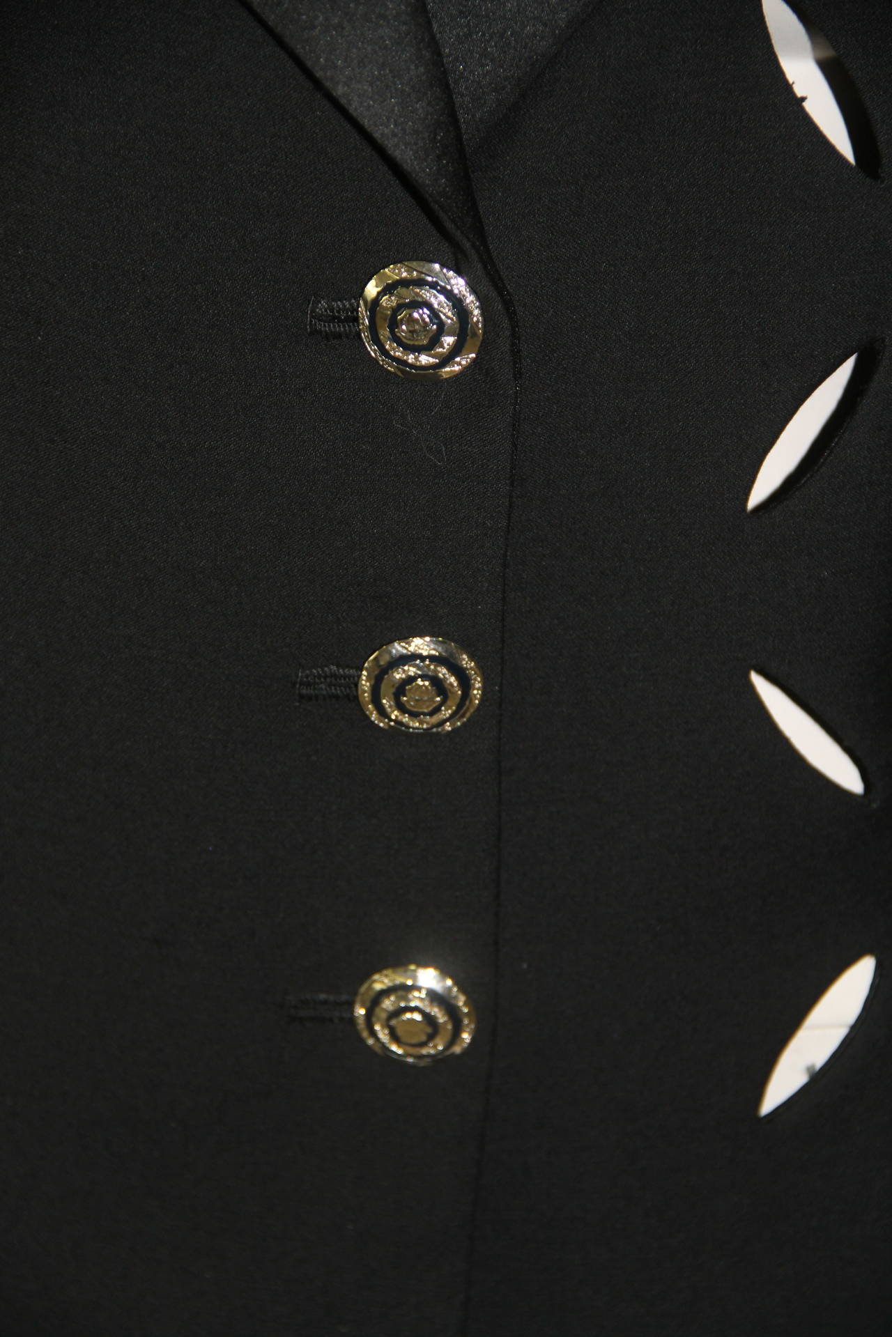 Gianni Versace black wool and silk cut-out three button tuxedo evening jacket from the Spring 1994 Punk collection.

Marked an Italian size 44.

Manufacturer - Alias S.p.a.

Fabric content - 100% wool with silk