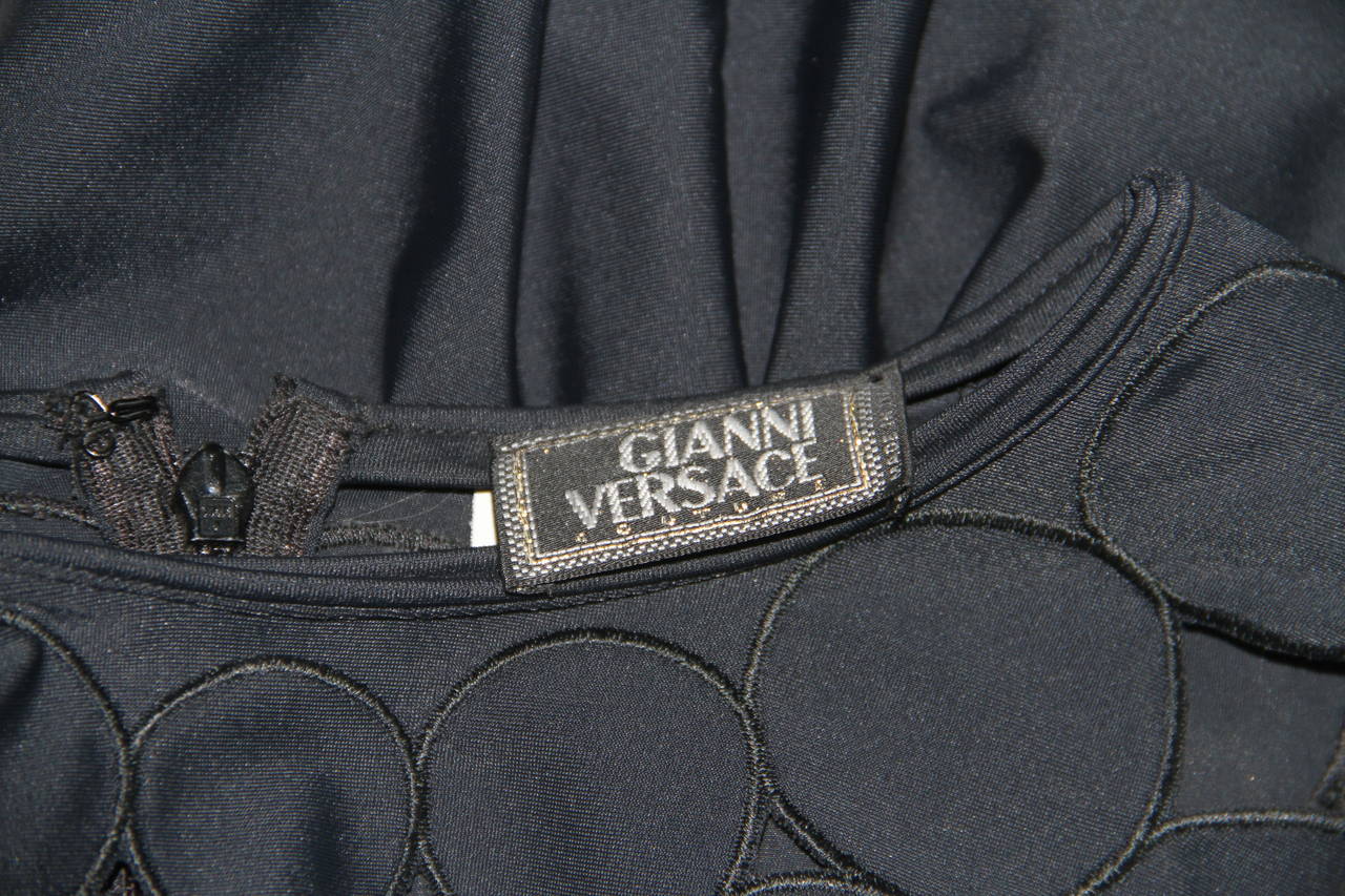 Gianni Versace black stretch cut-out detailing bodysuit from the Spring 1994 Punk collection.

Marked an Italian size 44.

Manufacturer - Alias S.p.a.

Fabric content - 79% nylon / 19% spandex / 2% cotton