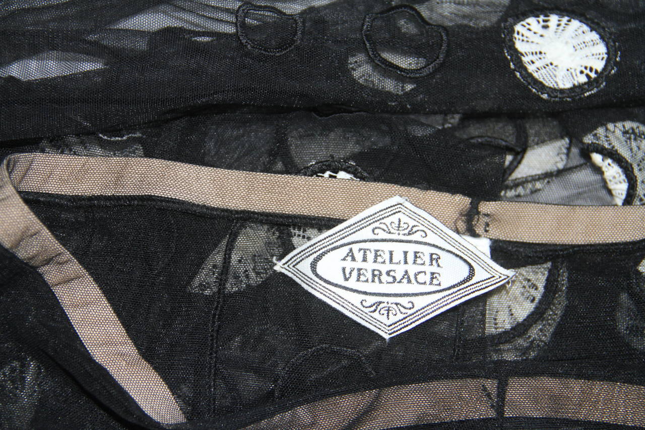 Very rare Atelier Versace silk leggings with a circle cut-out detailing from the Fall 1993 Haute Couture Punk collection, shown at The Ritz in Paris.

Unmarked, however, sizing is equivalent to an Italian size 40.

Manufacturer - Alias S.p.a.