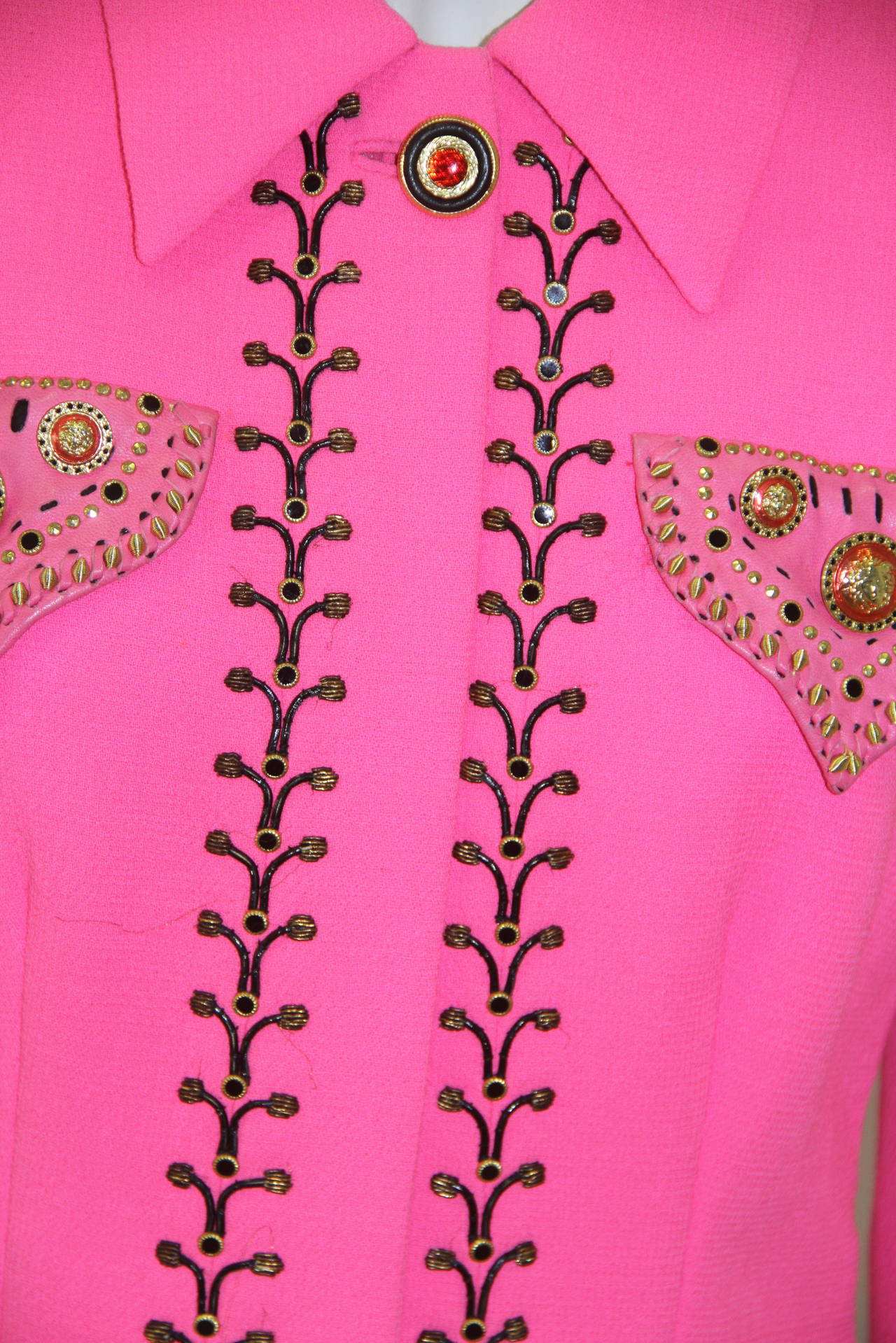 Museum Quality Atelier Versace shocking pink wool crepe cowgirl western inspired jacket from the Fall 1992 Atelier Bondage collection, shown at The Ritz in Paris.

The hand embroidered jacket features black thong embroidery, edged with gilt purl