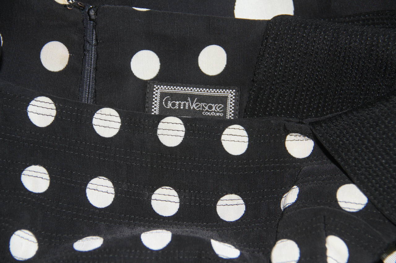 Iconic Gianni Versace black and white polka dot babydoll dress from the Spring 1991 Pop Art collection.

Marked an Italian size 38.

Manufacturer - Alias S.p.a.

Fabric content - 44% rayon / 20% silk / 36% cotton