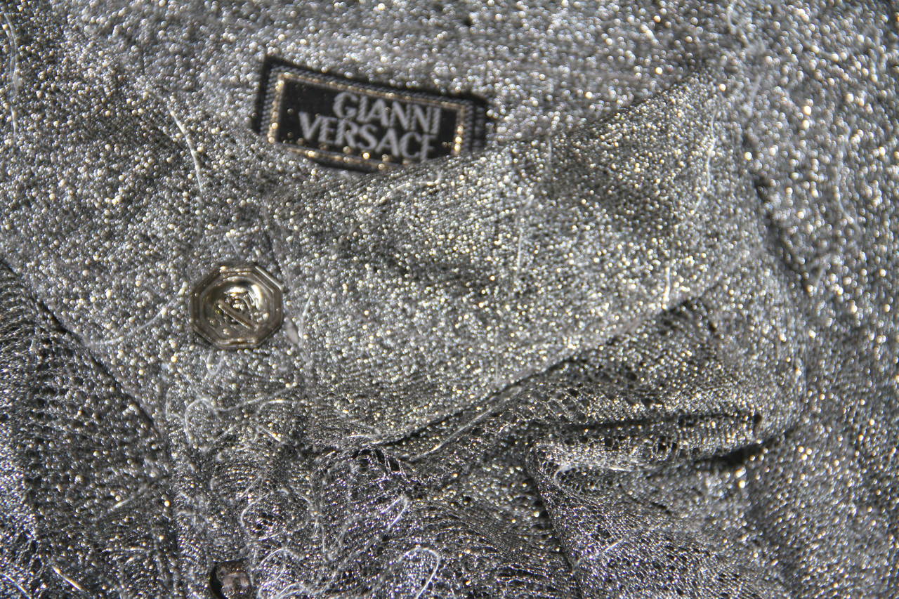 Gianni Versace silver lace net metal thread shirt from the Fall 1994 collection.

Marked an Italian size 40.

Manufacturer - Alias S.p.a.

Fabric content - 91% polyester / 9% cotton