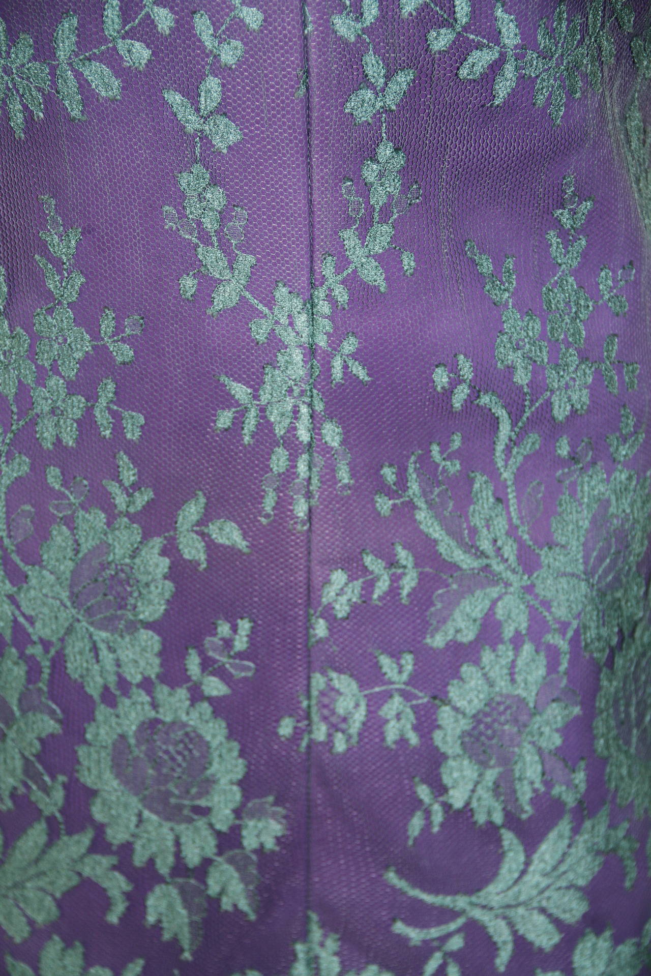 Gianni Versace purple leather fitted cocktail dress, with lace net overlay from 1996. The dress features metal and paste Medusa embossed strap detailing.

Unmarked, however, sizing is equivalent to an Italian size 40.

Manufacturer - Ruffo S.p.a.