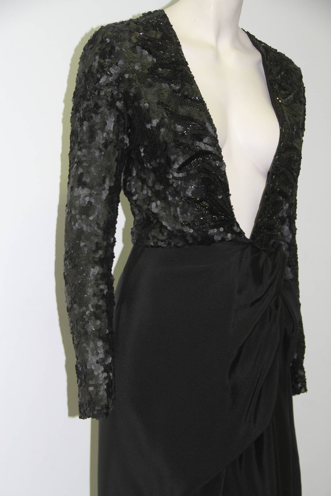 A rare and dramatic Paul-Louis Orrier plunge sequin embroidered black silk wrap cocktail dress from the 1980's.

Made in France.

Unmarked, however, sizing is equivalent to a French size 36.