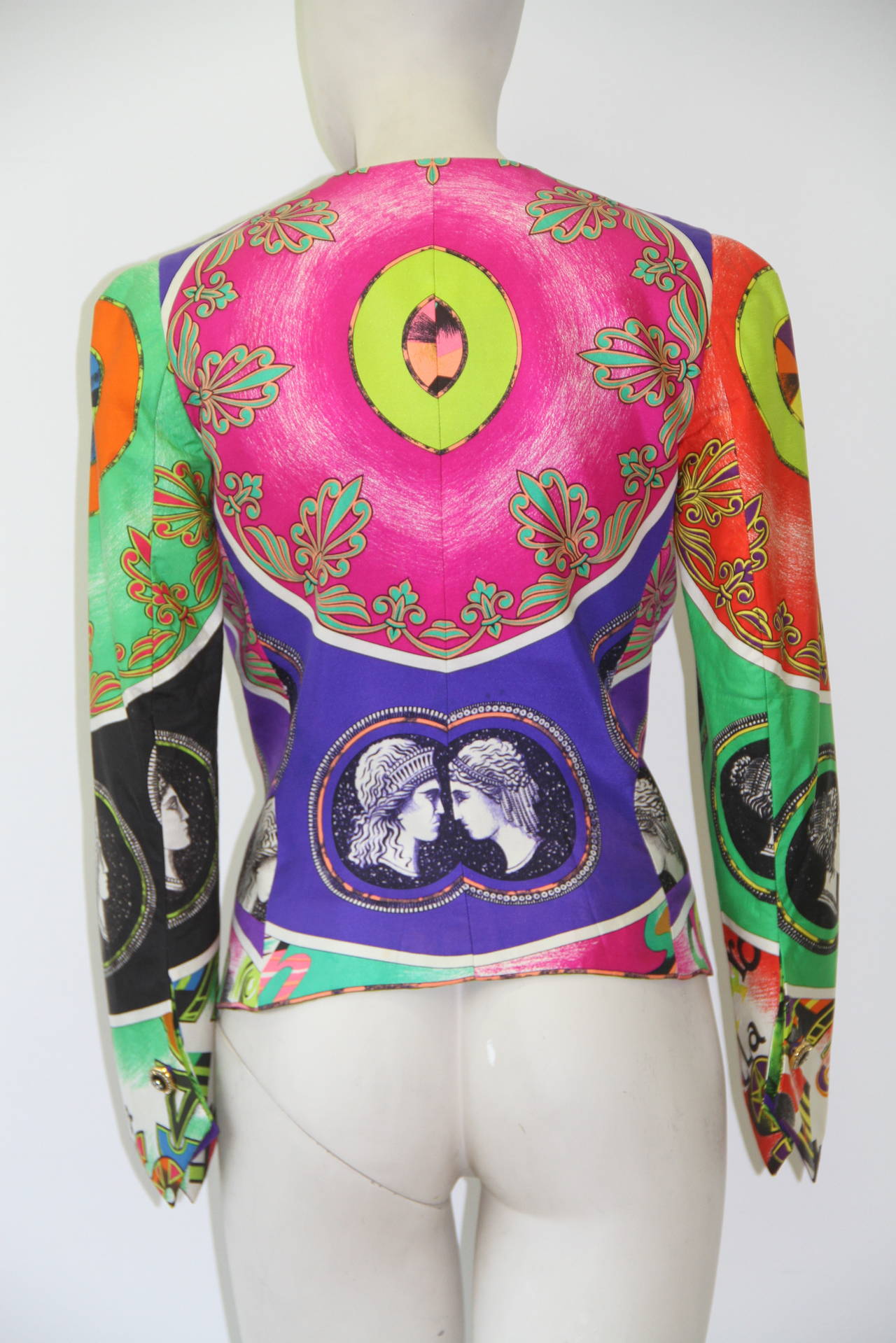 Iconic Gianni Versace silk Pop Art printed jacket from the Spring 1991 Pop Art collection.

The jacket is secured on the front and the cuffs, by a series of gold-tone metal, black jet and paste buttons. The jacket is fully lined in Pop Art printed