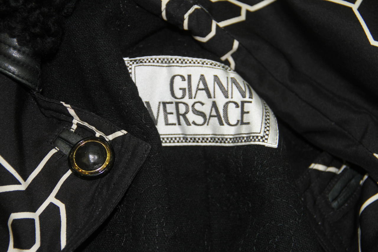 Gianni Versace optical printed silk raincoat, with astrakhan and leather collar from the Fall 1991 collection.

Marked an Italian size 40.

Manufacturer - Dismi '92 S.p.a.

Fabric content - 100% silk