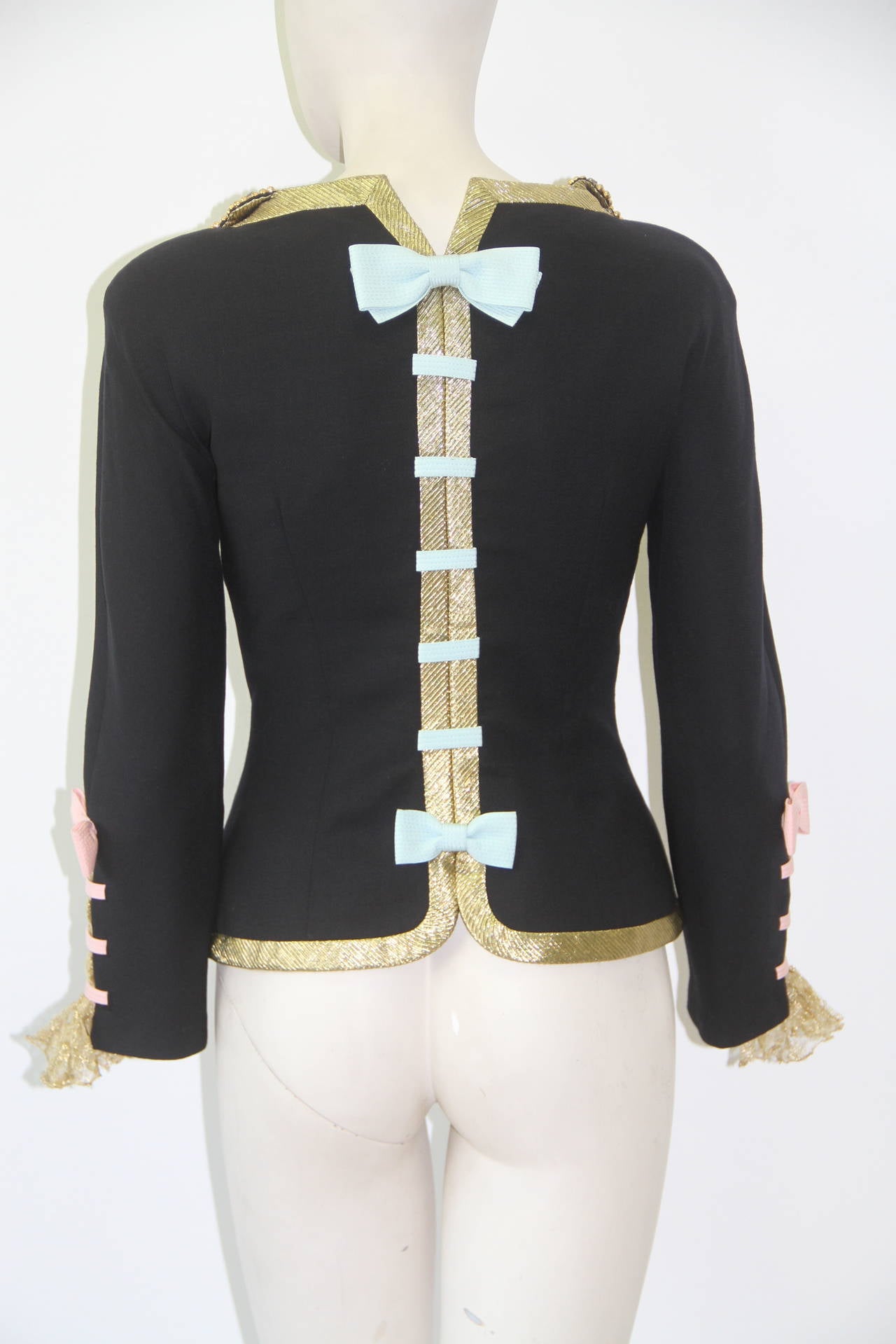 Gianni Versace hand embroidered jewelled evening jacket with bows and gold lurex braid edging, from the Spring 1992 collection.

The jacket is embroidered with blue jet and paste stones and gold silk thread. 

The jacket featured in the