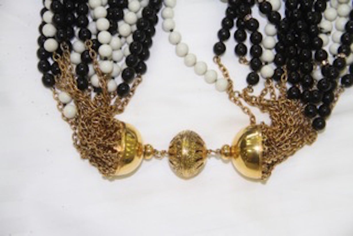Gianfranco Ferre dramatic black and white multi-strand necklace, strung from an ornate filigree gold-tone metal dome clasp, from the early 1990's.