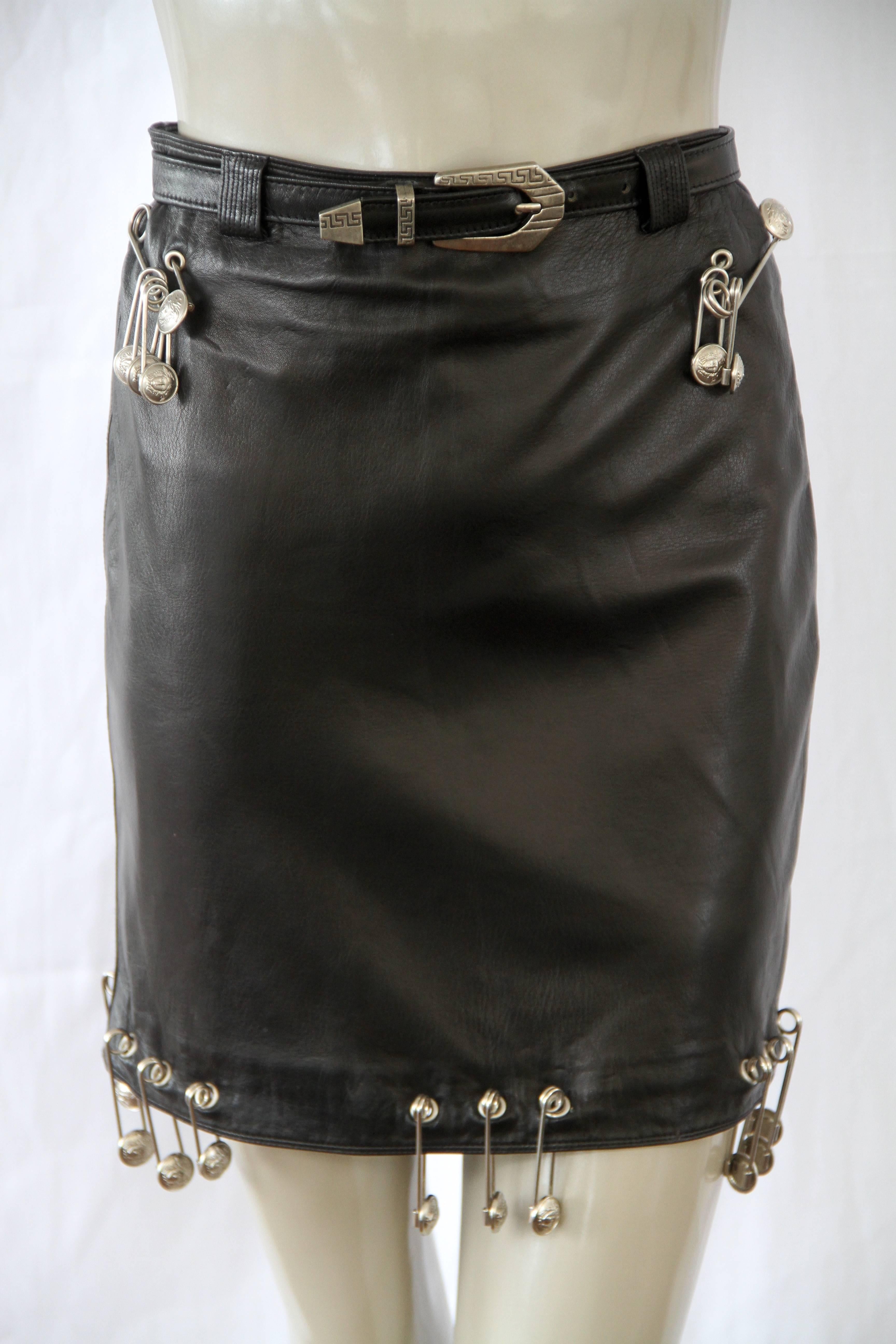 Iconic Gianni Versace black leather mini skirt, adorned with silver tone metal safety pins, from the Spring 1994 Punk collection.

Marked an Italian size 38.

Manufacturer - Ruffo S.p.a.

Fabric content - 100% leather,