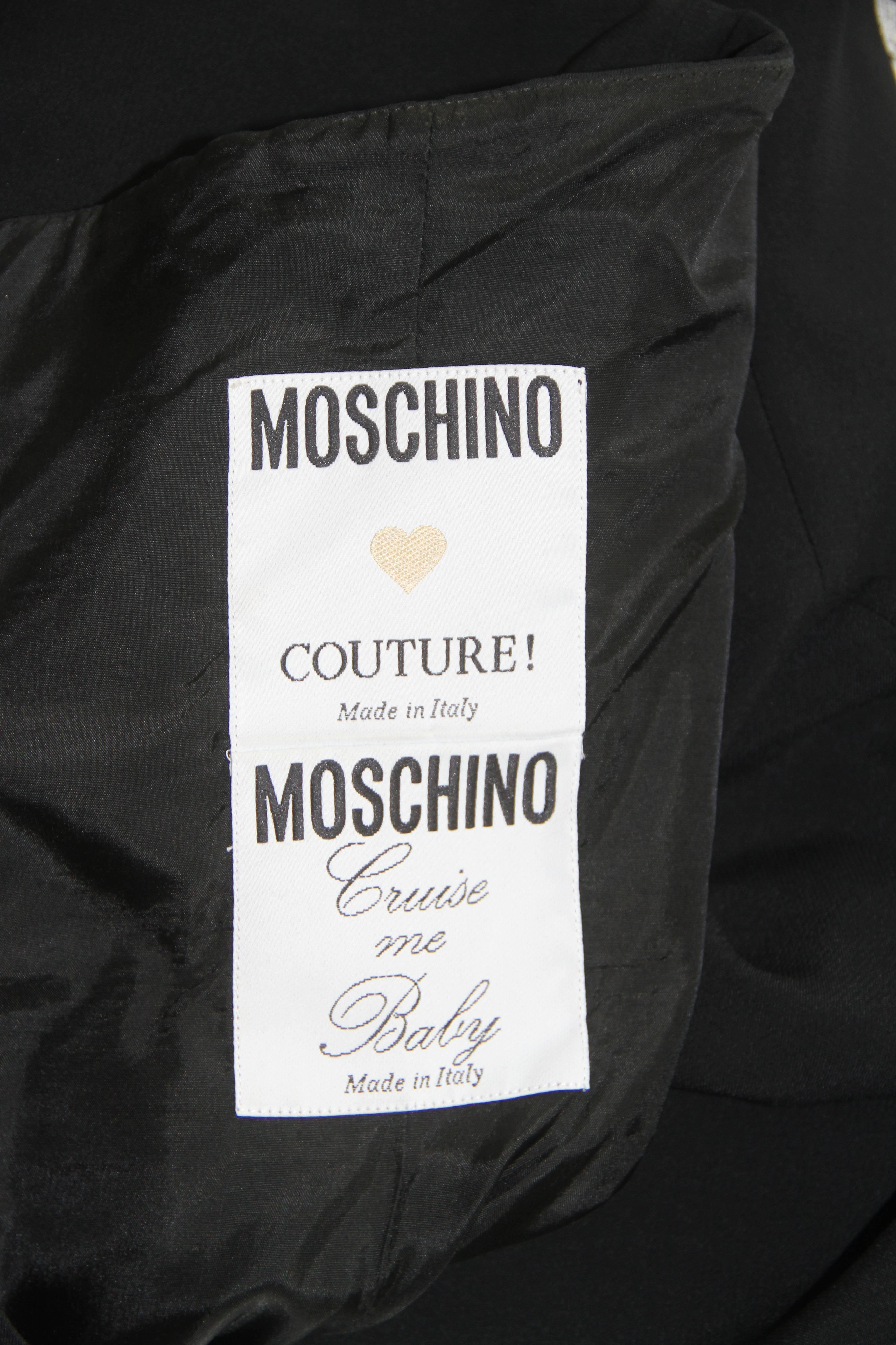 Moschino Couture Cruise Me Baby black silk blend wrap cocktail dress from the early 1990's.

Marked an Italian size 42.

Manufacturer - Aeffe S.p.a.