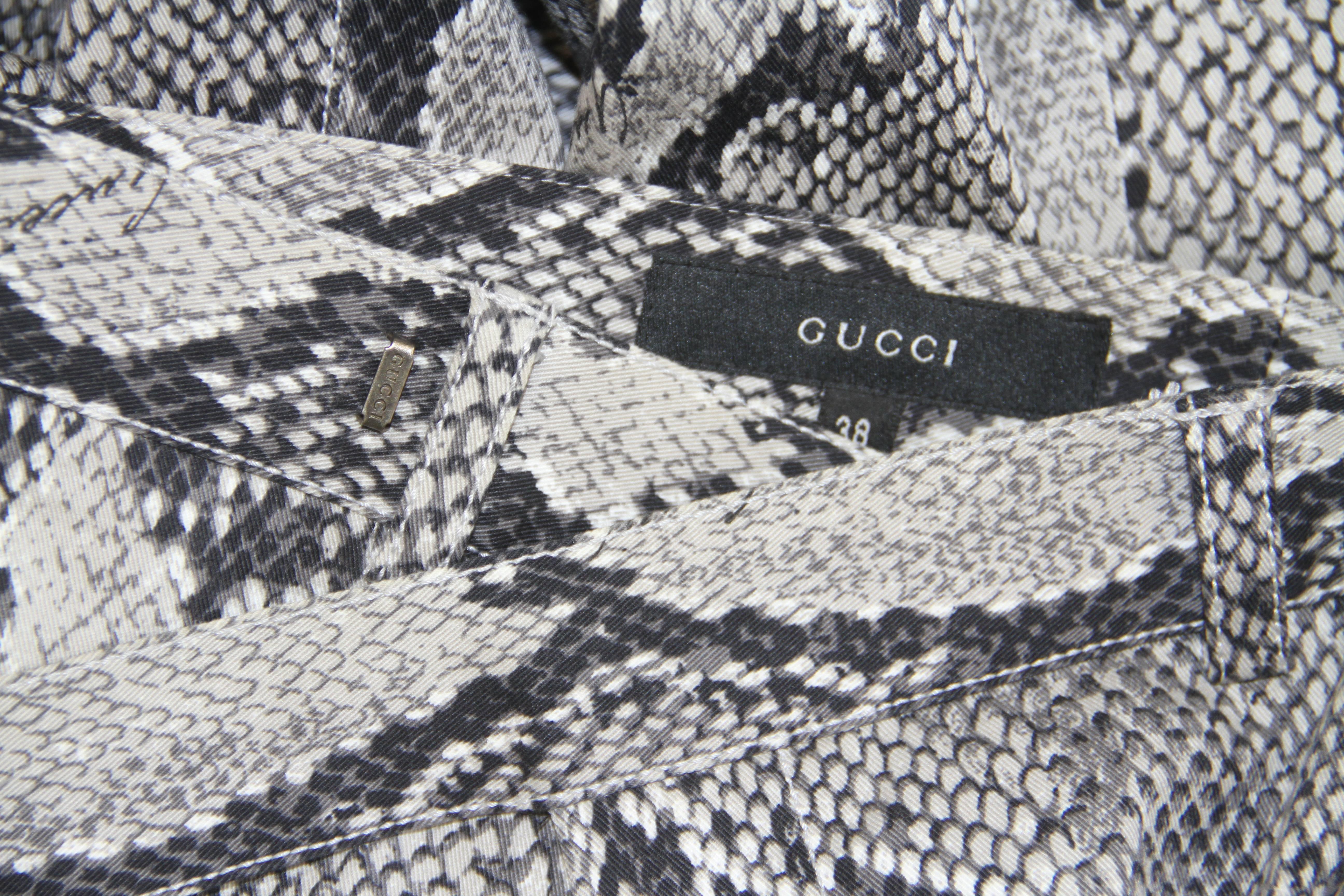 Iconic Tom Ford for Gucci python print ensemble from the Spring 2000 collection.

The top is marked an Italian size 40 and the pants are marked an Italian size 38.

Manufacturer - Zamasport S.p.a.

Fabric content - top - 100% rayon / pants -