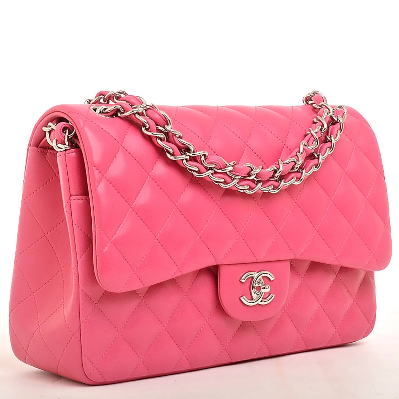 Chanel fuchsia pink Jumbo Classic double flap bag of quilted lambskin with silver tone hardware.

This limited edition Jumbo Classic double flap of fuchsia pink lambskin leather features a front flap with signature CC turnlock closure, half moon