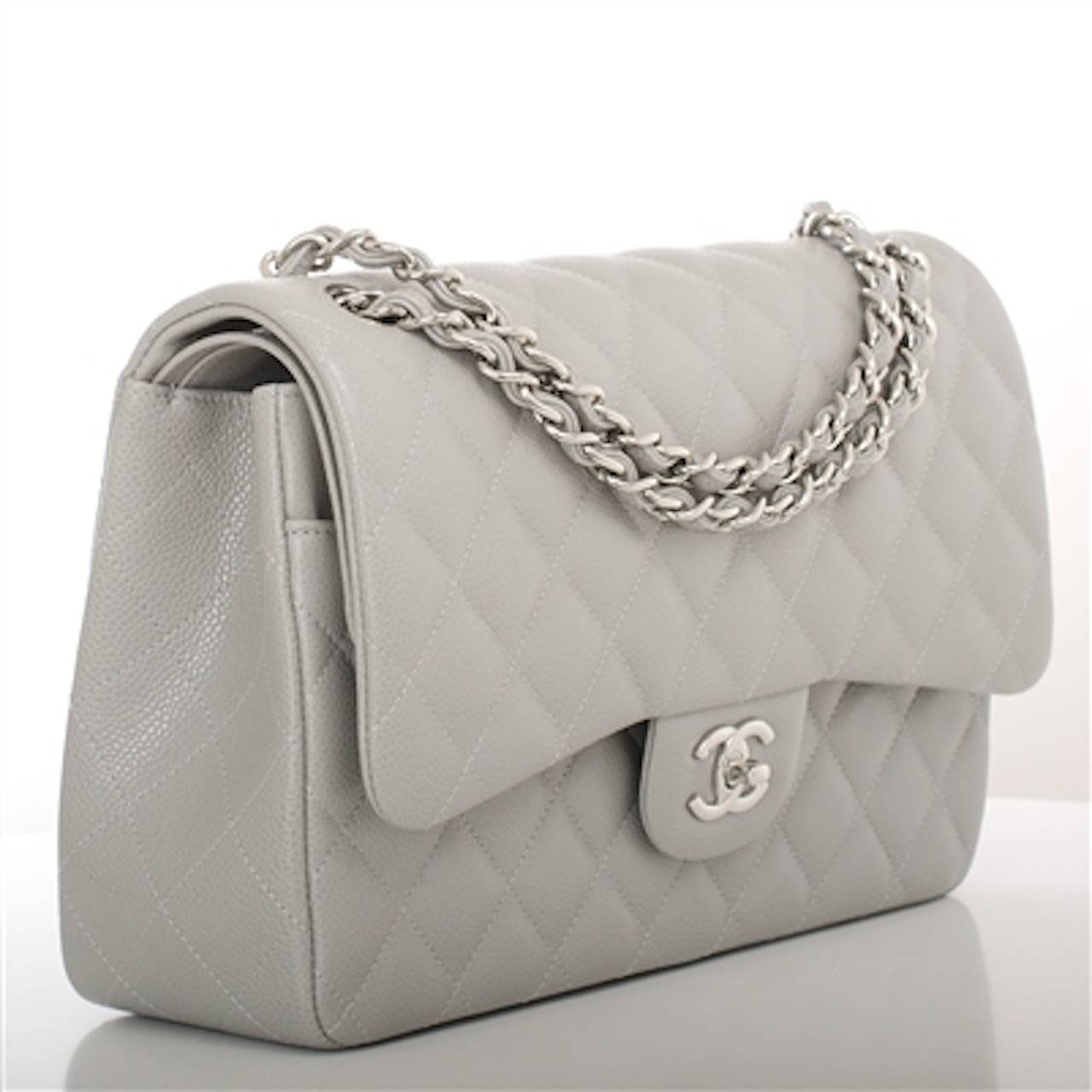 Chanel light grey Jumbo Classic double flap bag of quilted caviar leather with silver tone hardware.

This Jumbo Classic double flap of light grey quilted caviar leather features a front flap with signature CC turnlock closure, half moon back