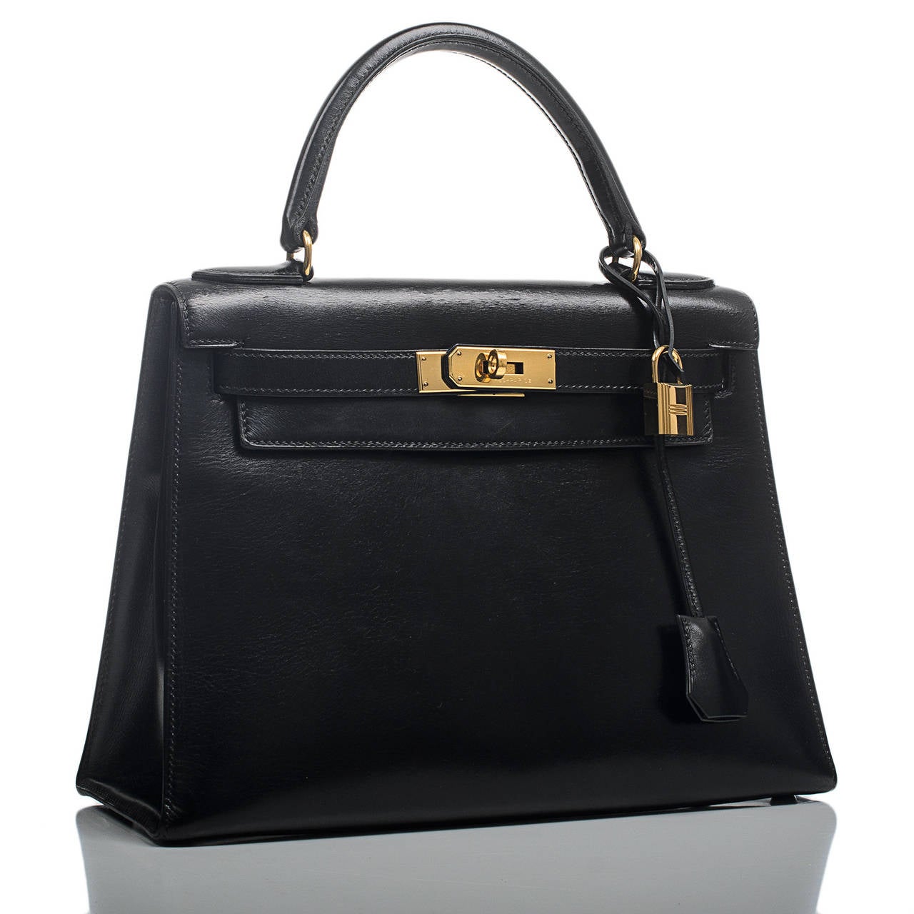 Hermes Kelly Sellier 28cm of black box leather with gold hardware.

The Hermes Kelly bag, like its sister bag -- the Birkin -- is a coveted and scarce bag. Like its muse, Grace Kelly, this bag is the definition of timeless elegance. The original