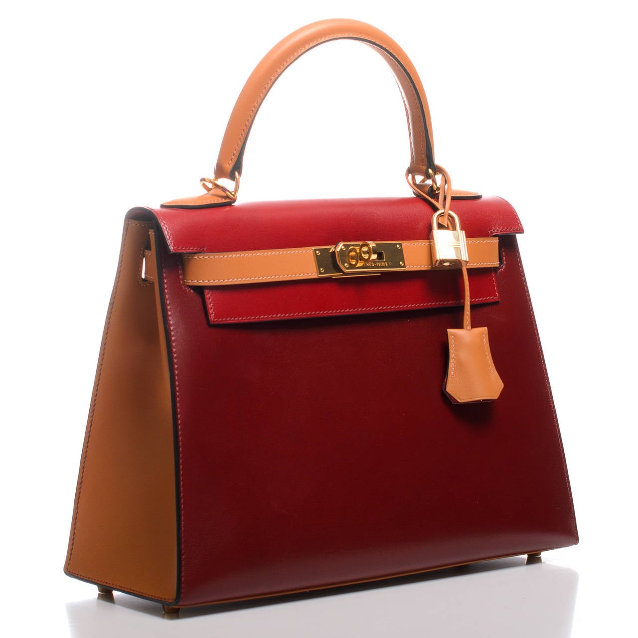 Hermes tri-color Kelly Sellier 28cm of Rouge H, Rouge Vif and Gold box leather with gold hardware.

The Hermes Kelly bag, like its sister bag -- the Birkin -- is a coveted and scarce bag. Like its muse, Grace Kelly, this bag is the definition of
