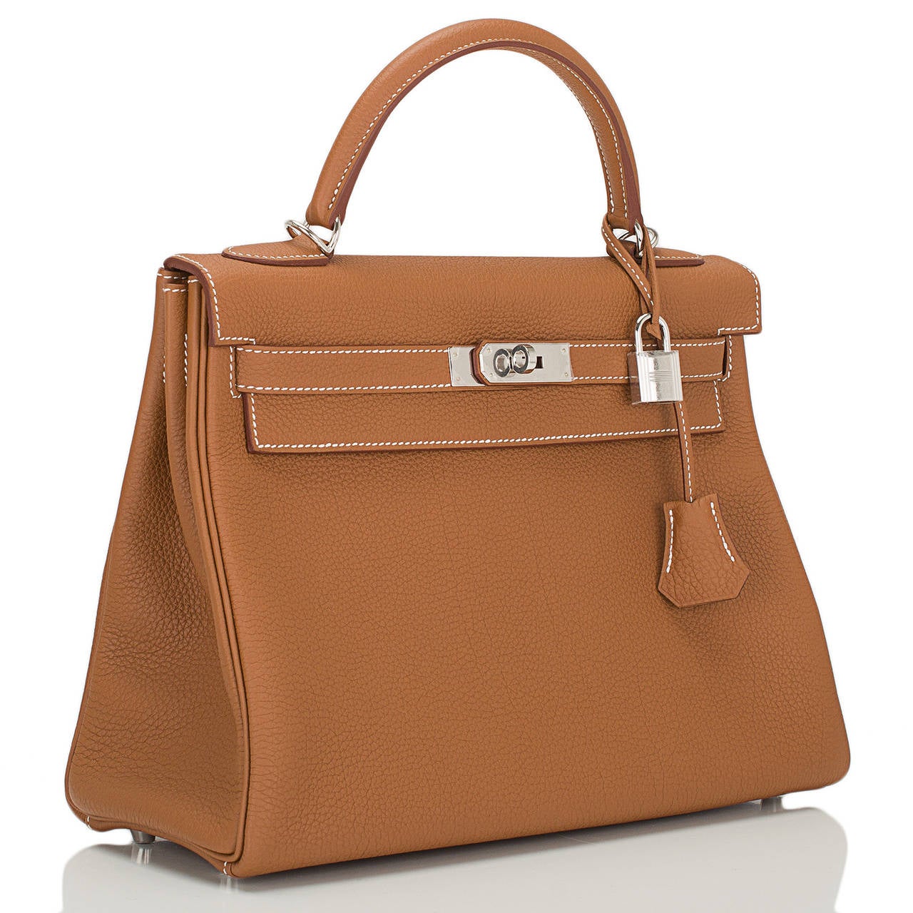 Hermes Gold Kelly 32cm in togo (bull) leather with palladium hardware.

The Hermes Kelly bag, like its sister bag -- the Birkin -- is a coveted and scarce bag. Like its muse, Grace Kelly, this bag is the definition of timeless elegance. The