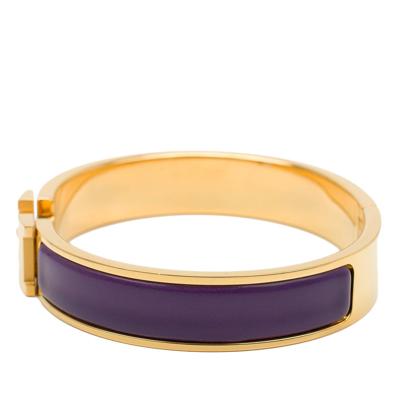 Hermes narrow Clic Clac H bracelet in purple enamel with gold plated hardware in size GM.

Hermes is renowned for its enamel and leather bracelets. Hermes printed enamel bangles, enamel Clic Clac H bracelets, and leather/exotic Collier de Chien