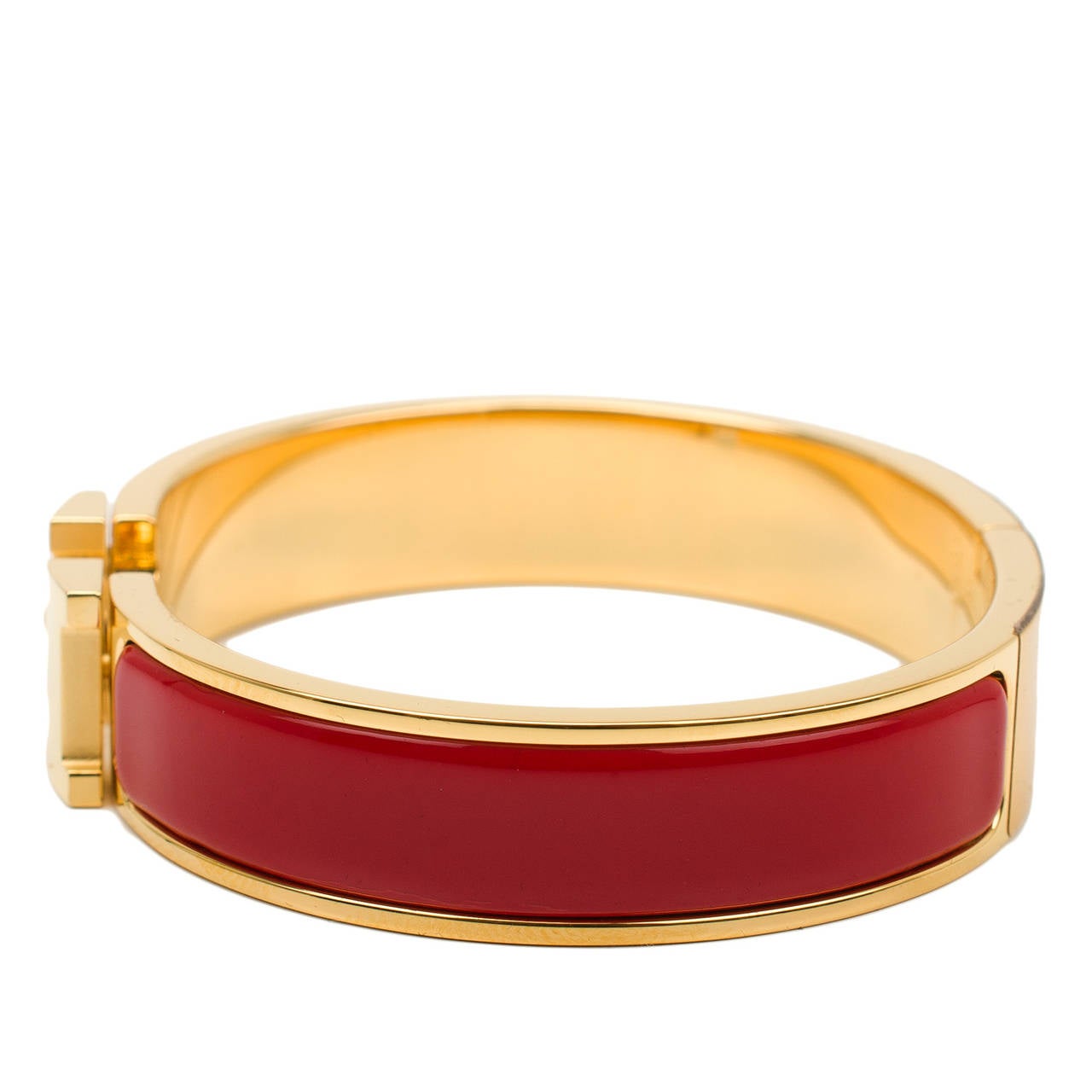 Hermes narrow Clic Clac H bracelet in Amaranth Red enamel with gold plated hardware in size PM.

Hermes is renowned for its enamel and leather bracelets. Hermes printed enamel bangles, enamel Clic Clac H bracelets, and leather/exotic Collier de