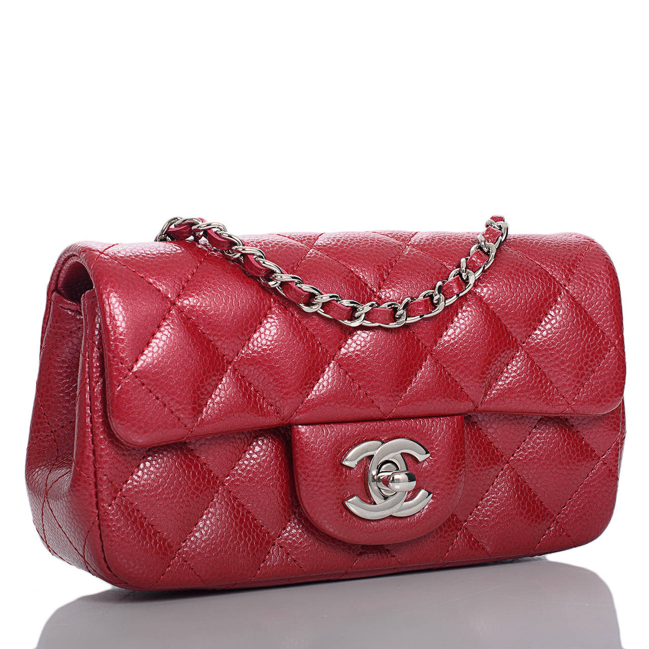 This Mini flap bag is a youthful and compact version of Chanel's signature Classic bags...marrying dark pink glazed caviar leather with silver tone hardware. Worn on the shoulder or across the body, this bag offers a high fashion,hands-free approach