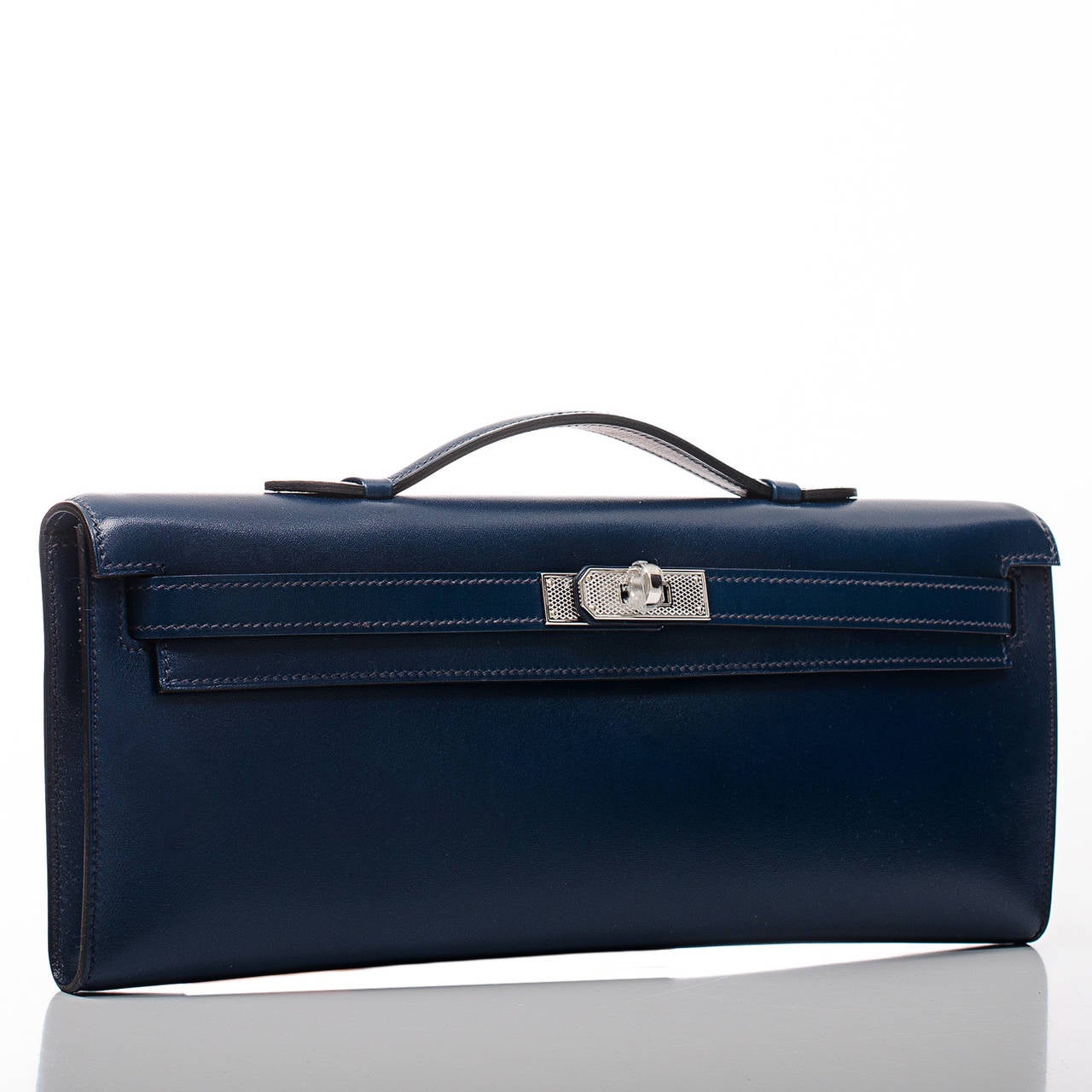 Hermes Blue de Prusse Kelly Cut clutch in box (smooth calfskin) leather with palladium guilloche hardware.

Hermes introduced the Kelly Cut in the fall/winter collection in 2006. The long, sleek lines with the small handle accented by the iconic