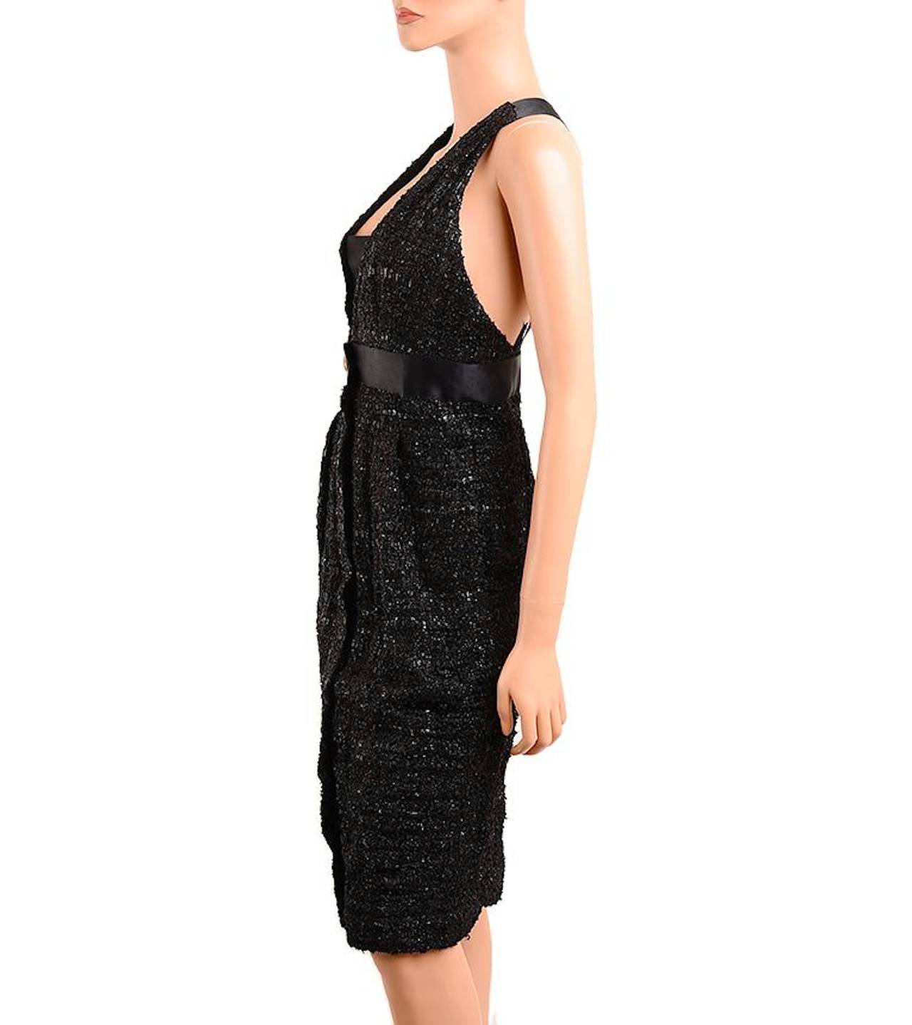 Chanel black lurex fantasy tweed boucle dress with black silk trim, deep v front with removable snap-on center panel, empire banded waist with black and gold Chanel stamped button, front zipper closure behind center placket and rear criss-cross