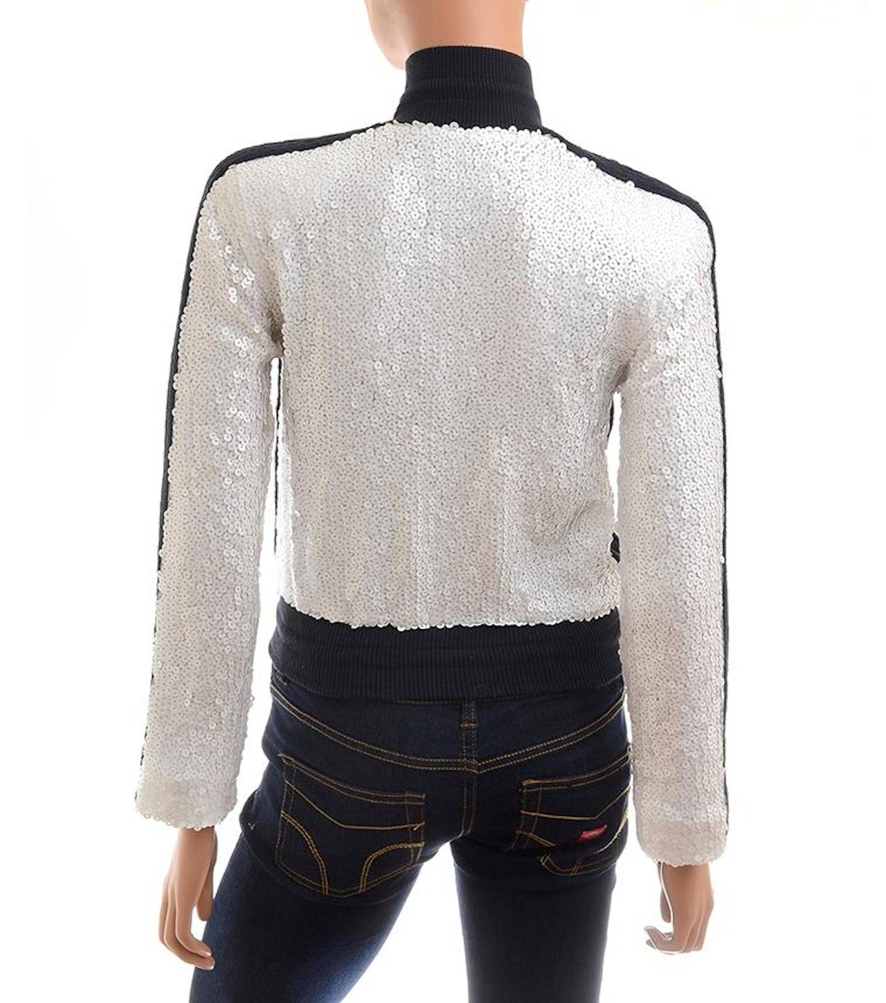 Chanel white sequin baseball sweater jacket with all over navy fabric trim, ribbed high collar with drawstring closure, front hidden zipper closure with silvertone square CC pull, side pockets with square CC pulls, ribbed hem with drawstring