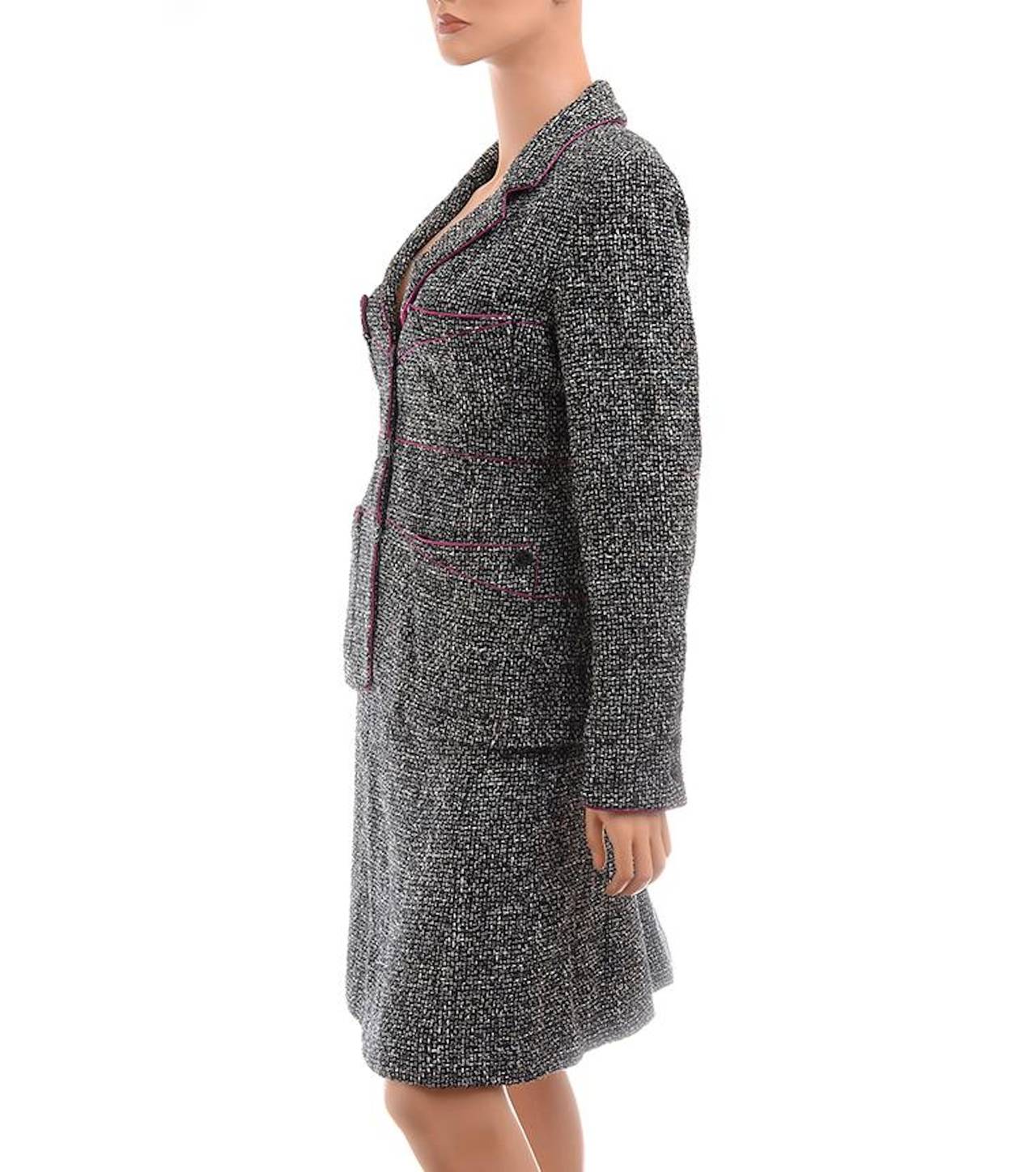 Chanel black and white basket weave patterned boucle skirt suit comprising jacket with allover magenta trim, notch collar and lapels, three front cc logo button closure, four front patch pockets, long sleeve with three buttons on each cuff, and