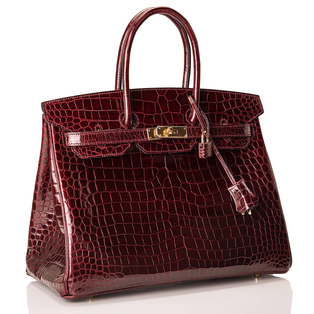 Hermes Bordeaux Birkin 35cm in Porosus crocodile with gold hardware.

This Birkin features tonal stitching, front toggle closure, clochette with lock and two keys, and double rolled handles. The interior is lined in Bordeaux chevre with one zip