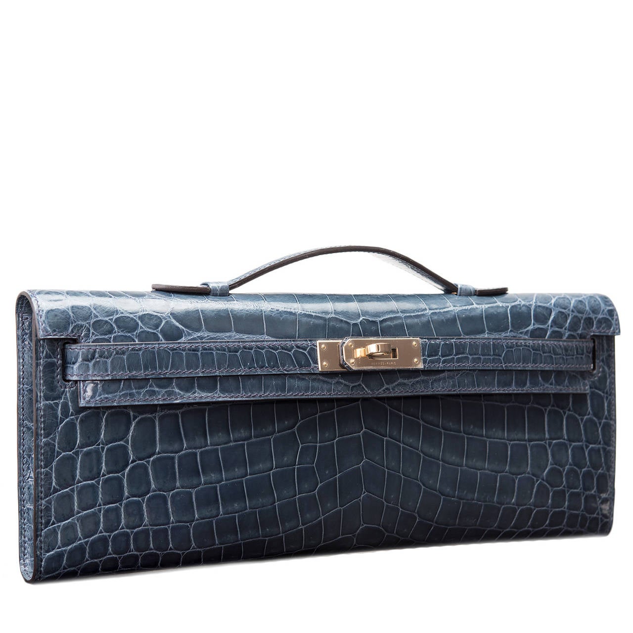 Hermes Bleu Izmir shiny niloticus crocodile Kelly Cut with permabrass hardware.

This Kelly Cut in a Hermes' favorite color -- Blue Tempete -- is a gorgeous blue that is elegant with rare Nilo crocodile skin and permabrass hardware; the bag has