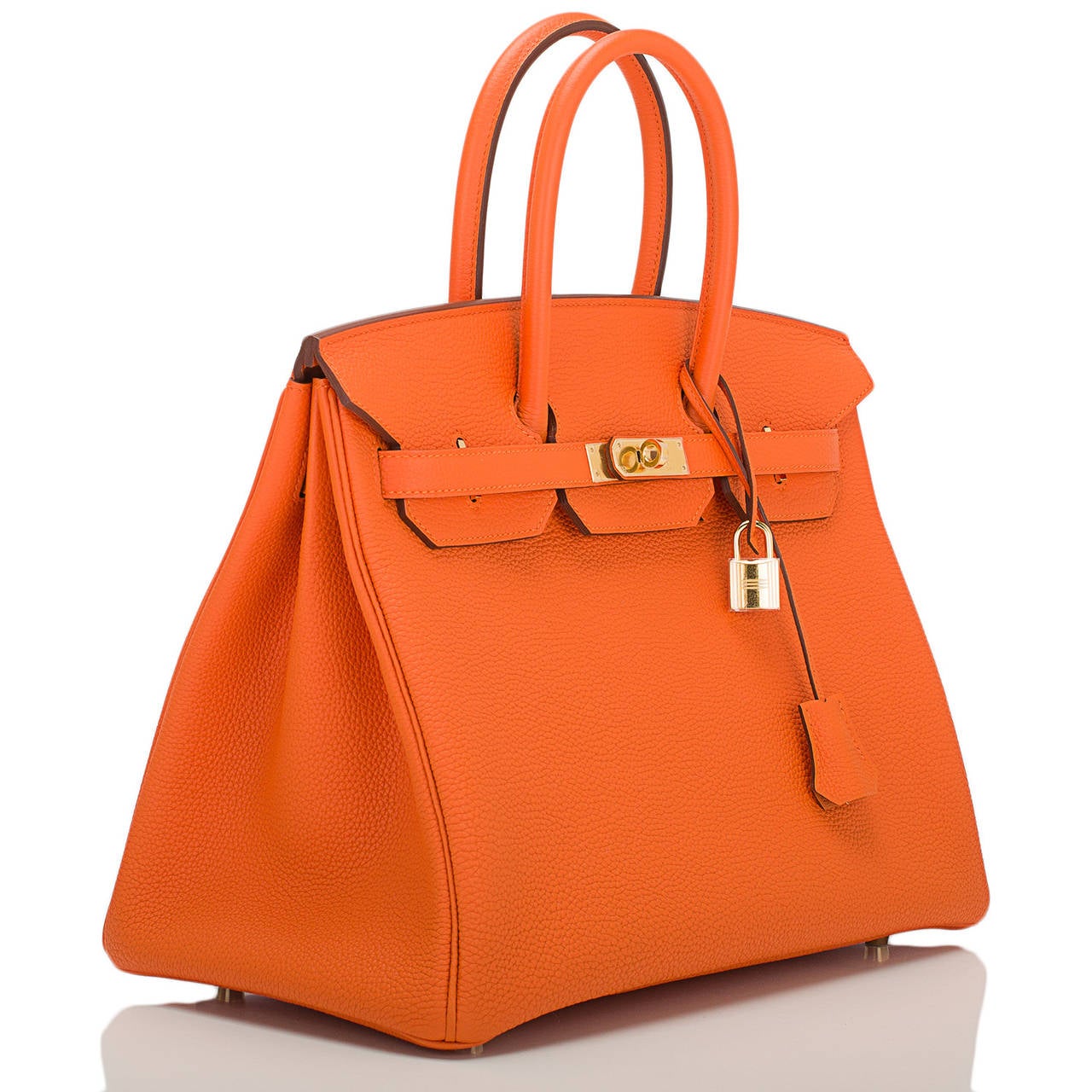 Hermes Orange H Birkin 35cm in togo (bull) leather with gold hardware.

This Birkin features tonal stitching, front toggle closure, clochette with lock and two keys, and double rolled handles. The interior is lined in Orange H chevre with one zip