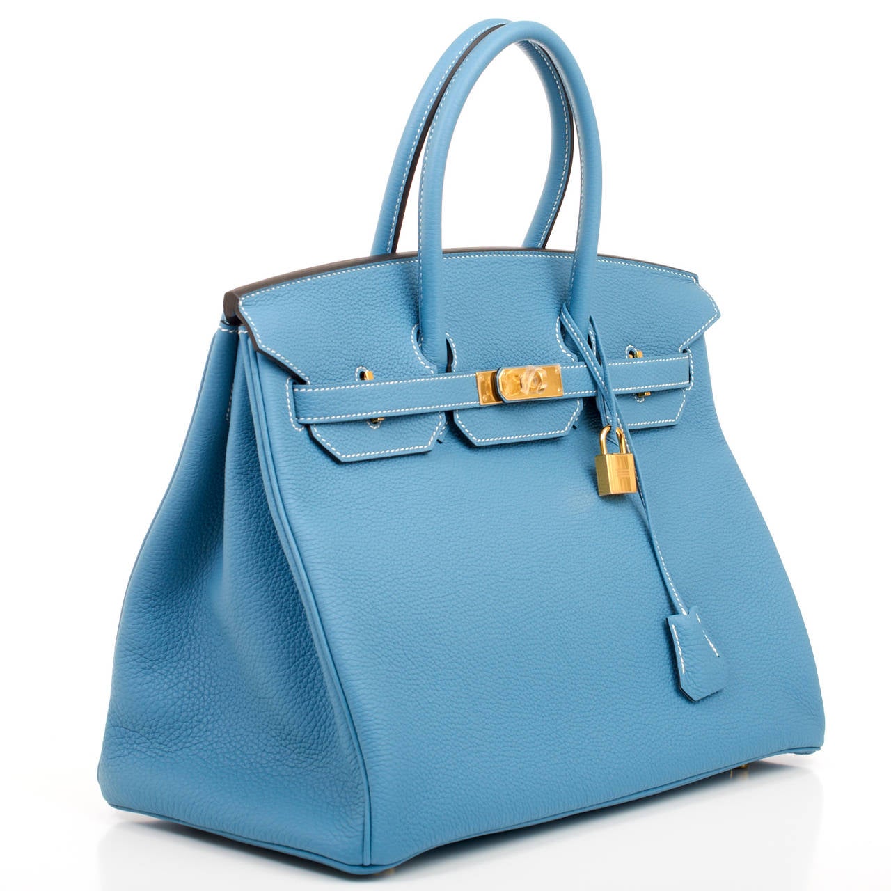 Hermes Blue Jean Birkin 35cm in togo (bull) leather with gold hardware.

This Birkin features white contrast stitching, front toggle closure, clochette with lock and two keys, and double rolled handles. The interior is lined in Blue Jean chevre