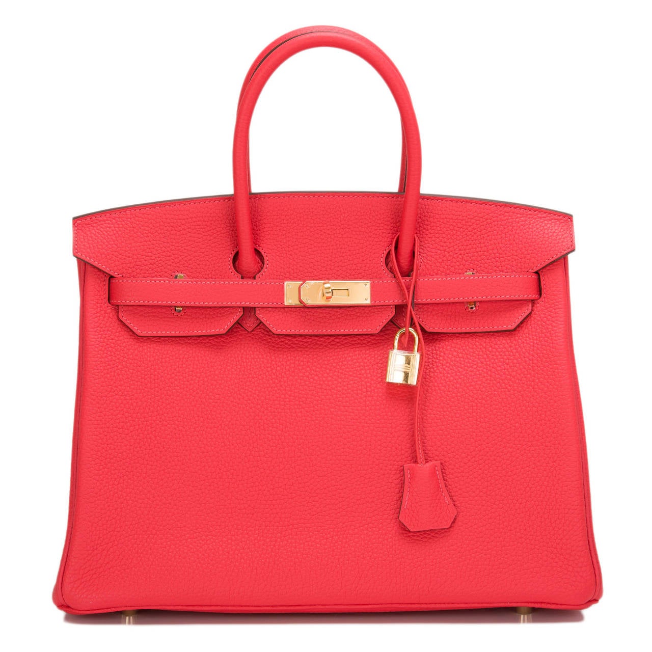 Hermes Rouge Pivoine Birkin 35cm in togo (bull) leather with gold hardware.

The Hermes Birkin is the most coveted and the hardest to acquire handbag in the world. Immediately recognizable by its shape, its thin straps with metal plates on the end