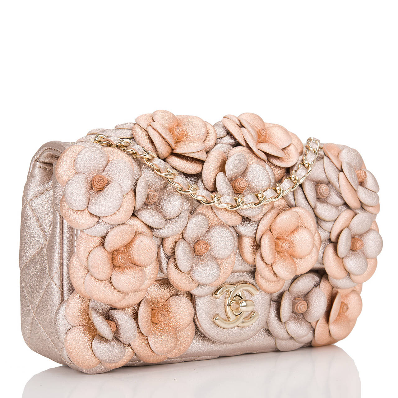 This Chanel Camellia flap bag featuring beautiful hand stitched pink and silver leather camellia flowers is fast becoming a collectible amongst Chanel lovers. This gorgeous Chanel bag features a front flap with signature gold tone CC turnlock