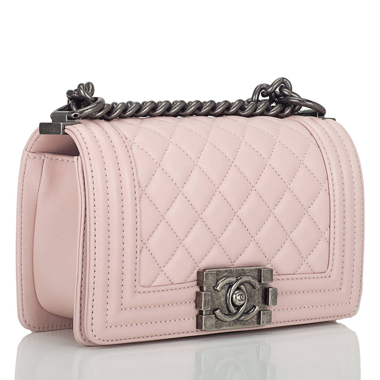 Chanel Small Boy bag of light pink lambskin leather with aged ruthenium hardware.

This Boy Bag has a full front flap with the Boy signature CC push lock closure with an aged ruthenium chain link and light pink leather padded shoulder/crossbody